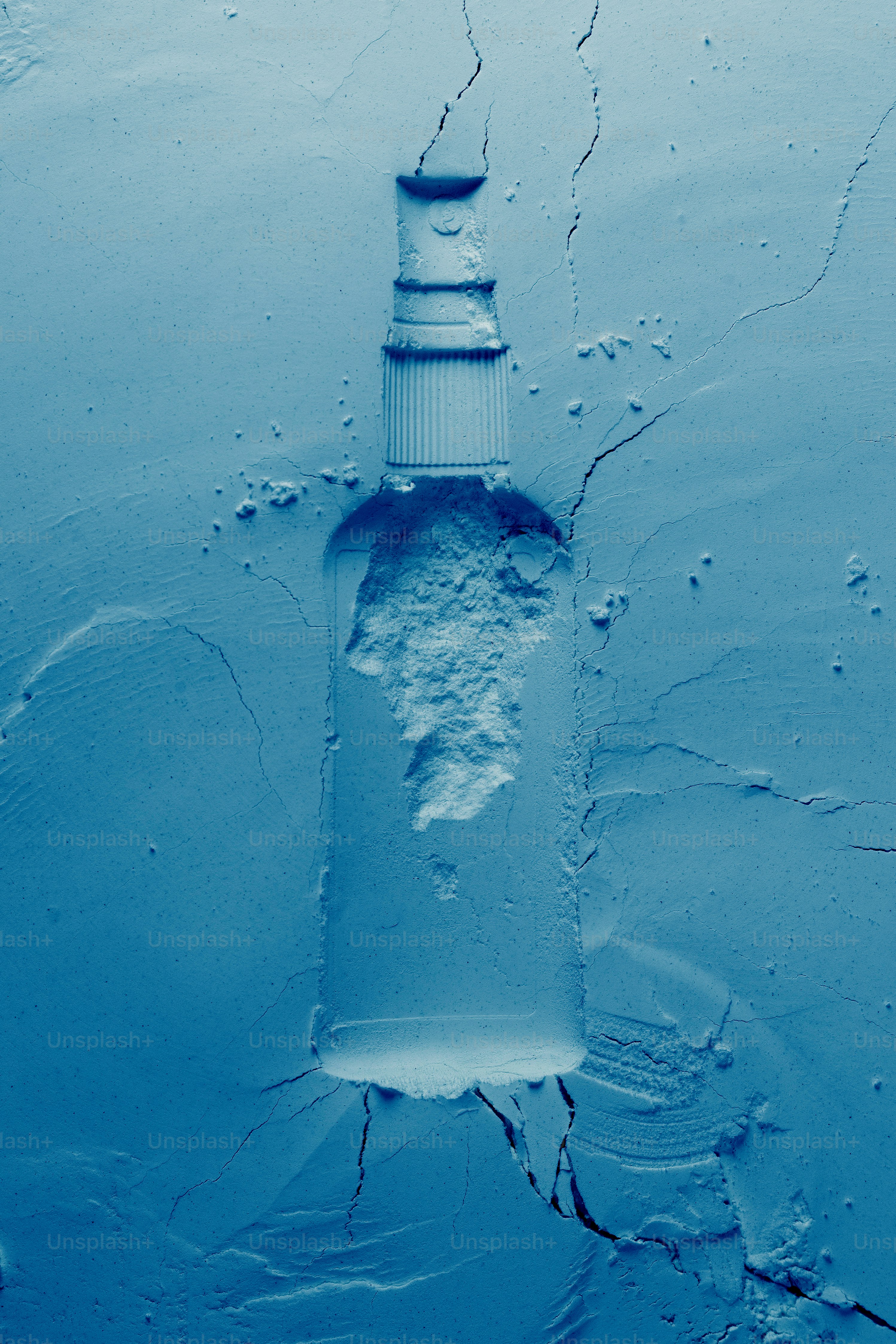 A blue bottle covered in powder