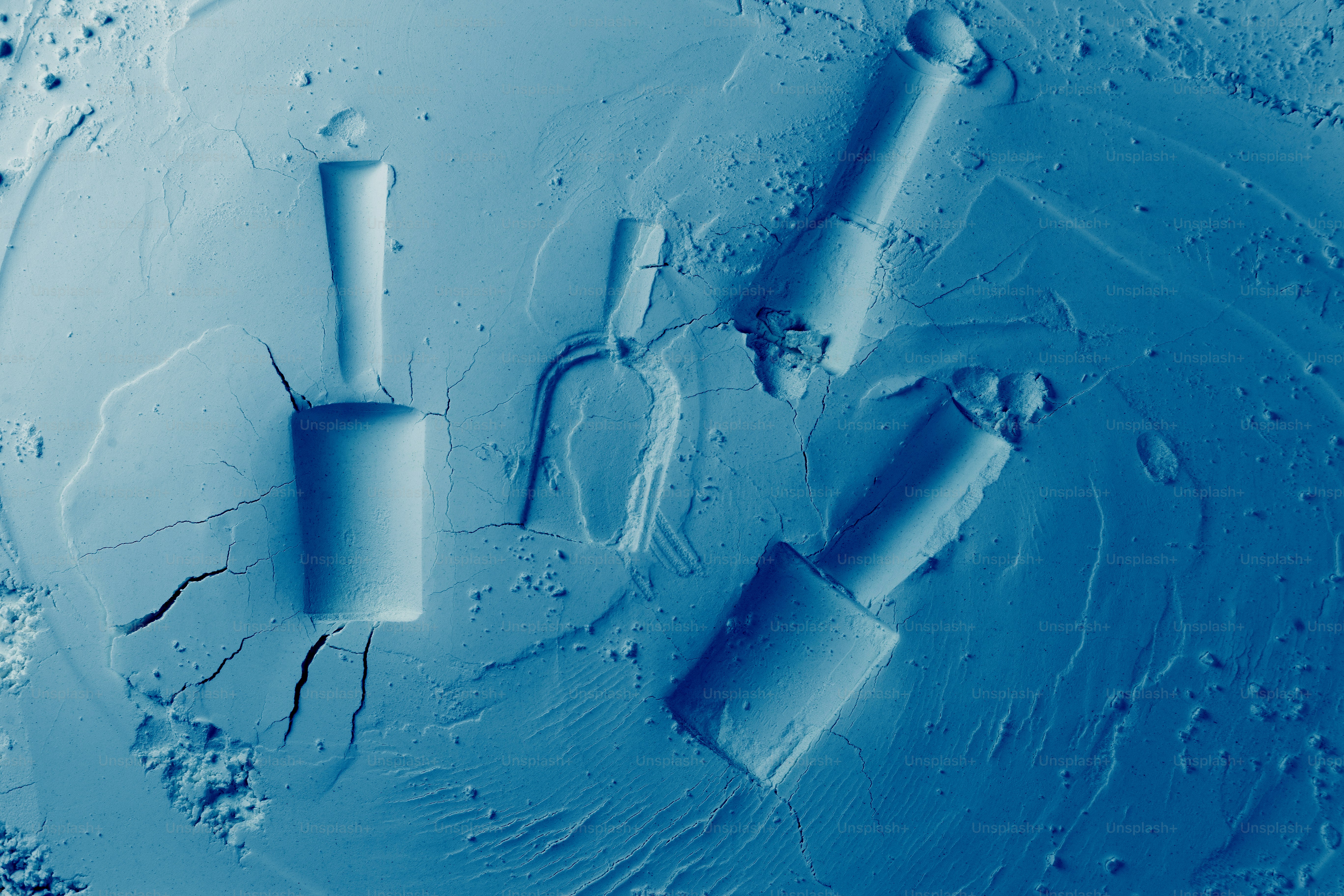 Three nail polish bottles arranged on a blue surface