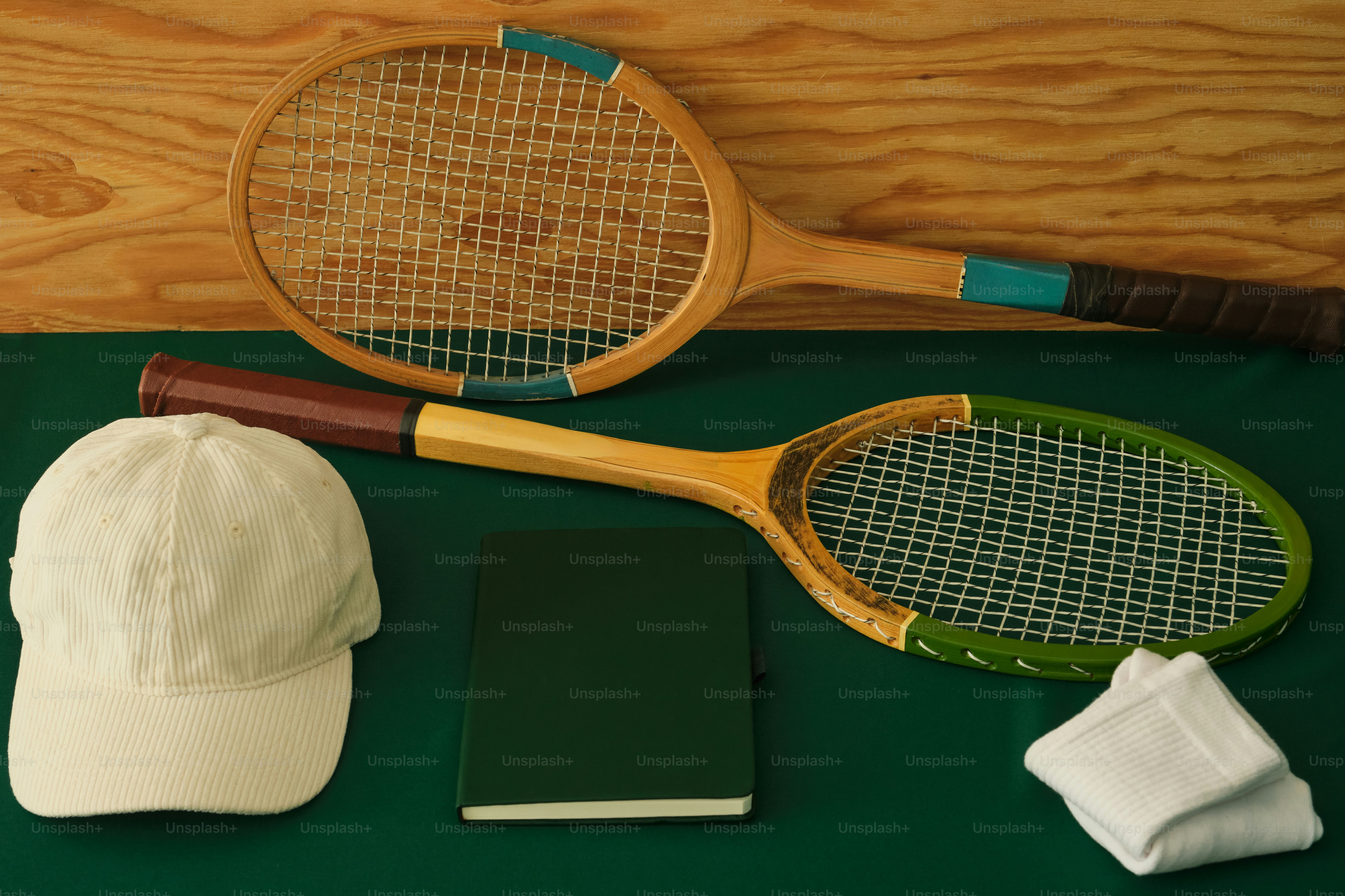 Two vintage tennis rackets, cap, notebook, and towel photo – Tennis ...