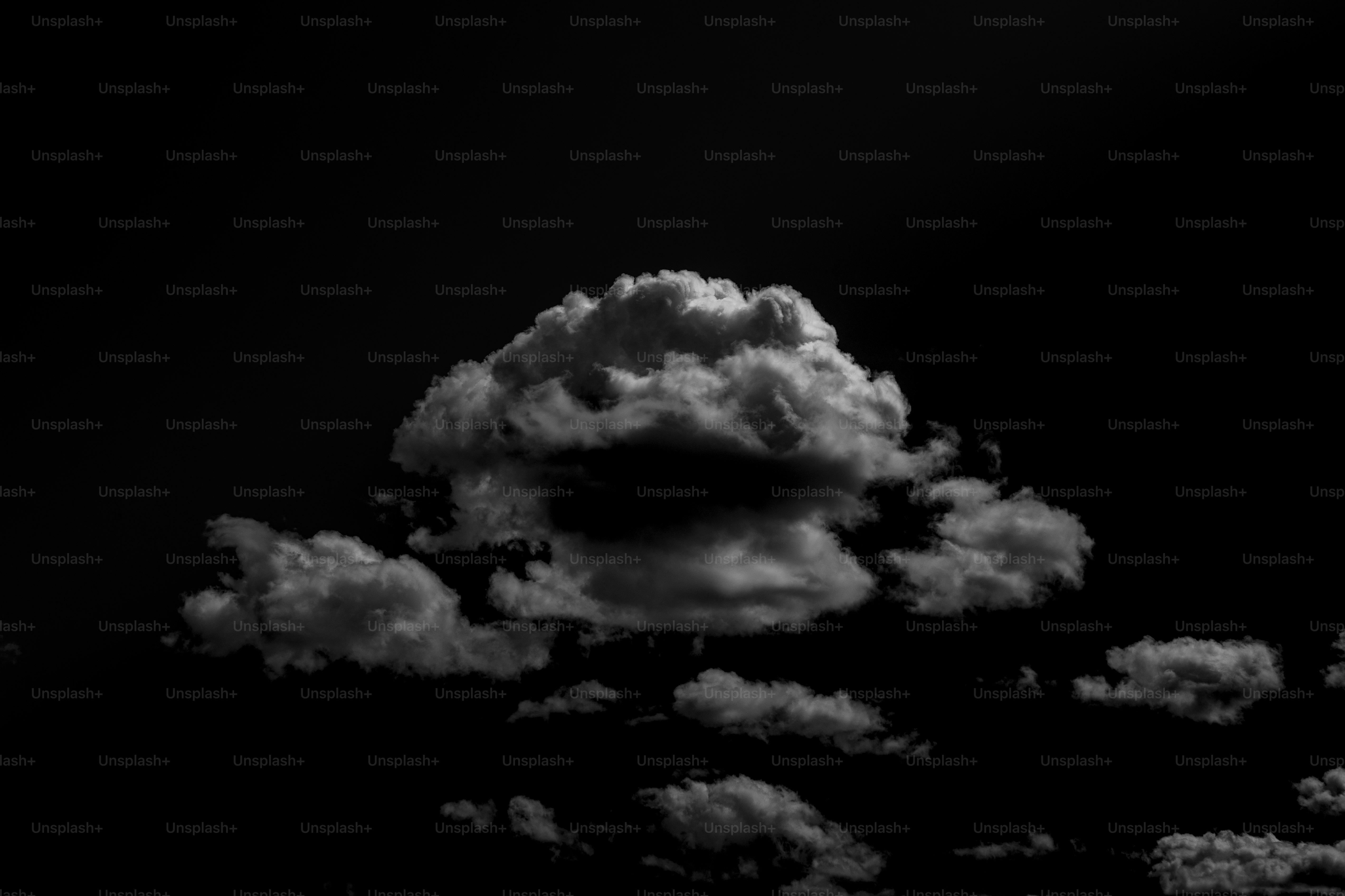 Fluffy white clouds against a black sky