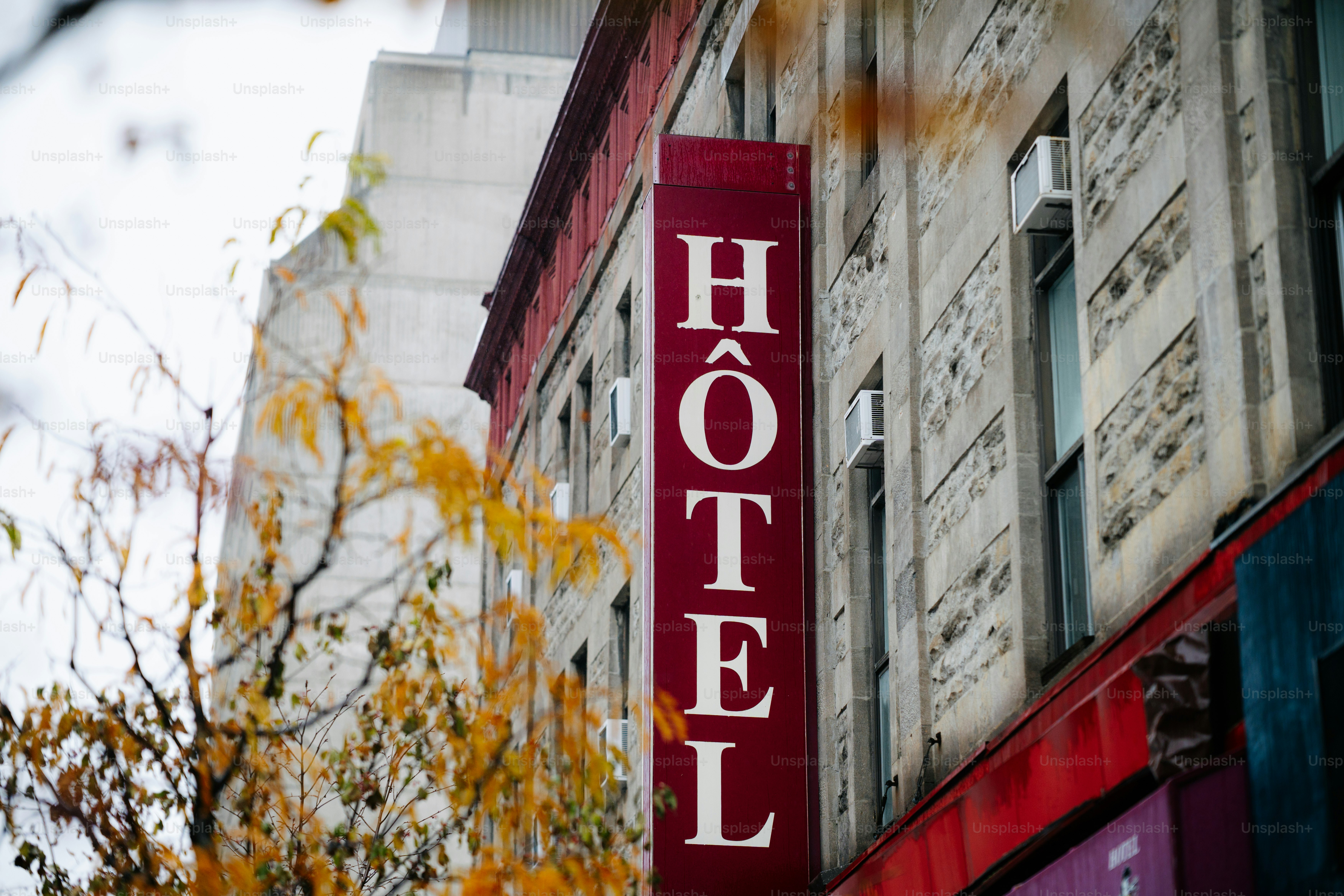 Vertical hotel sign on a stone building