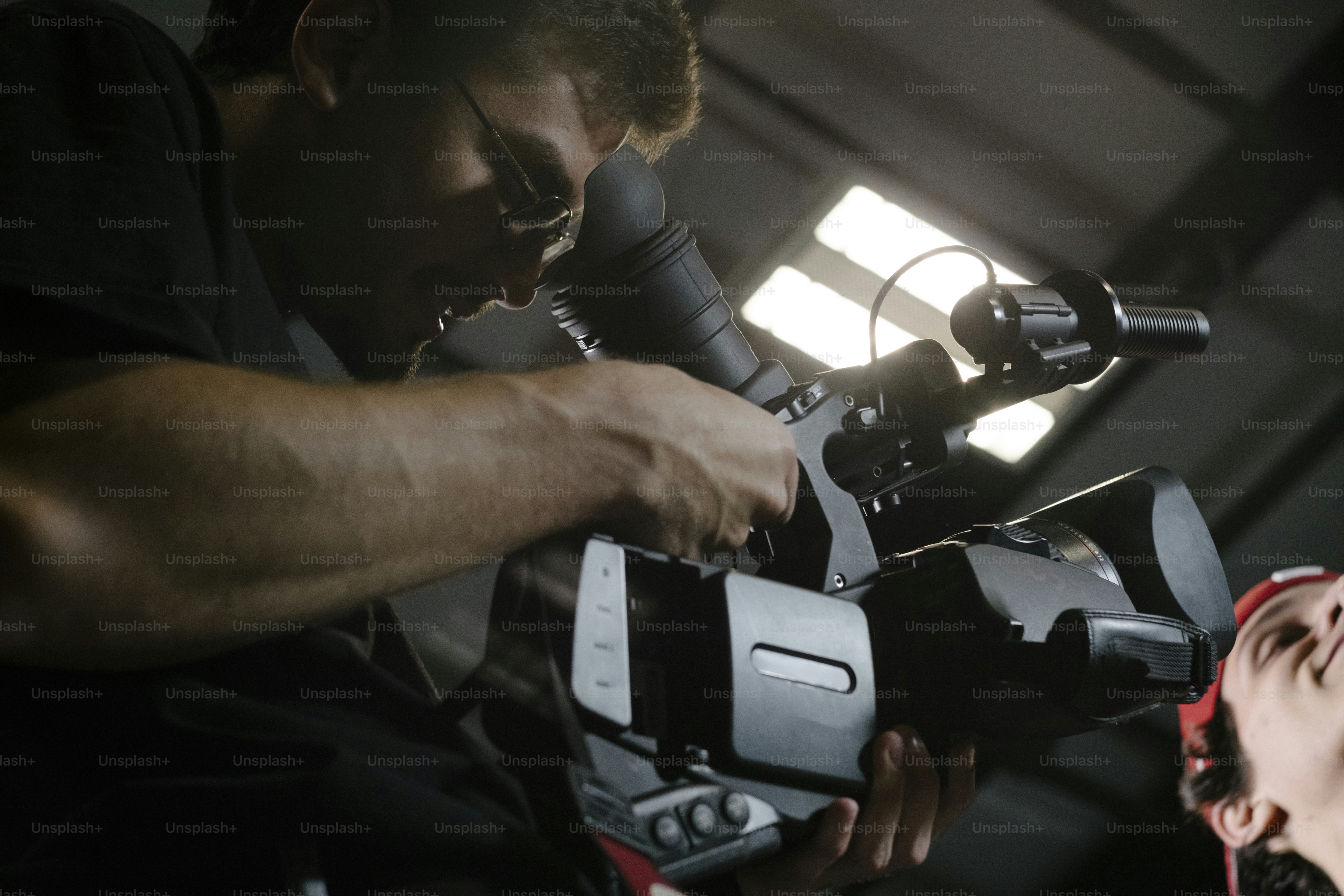 Filmmaker operating a professional video camera photo – Cinematic Image ...