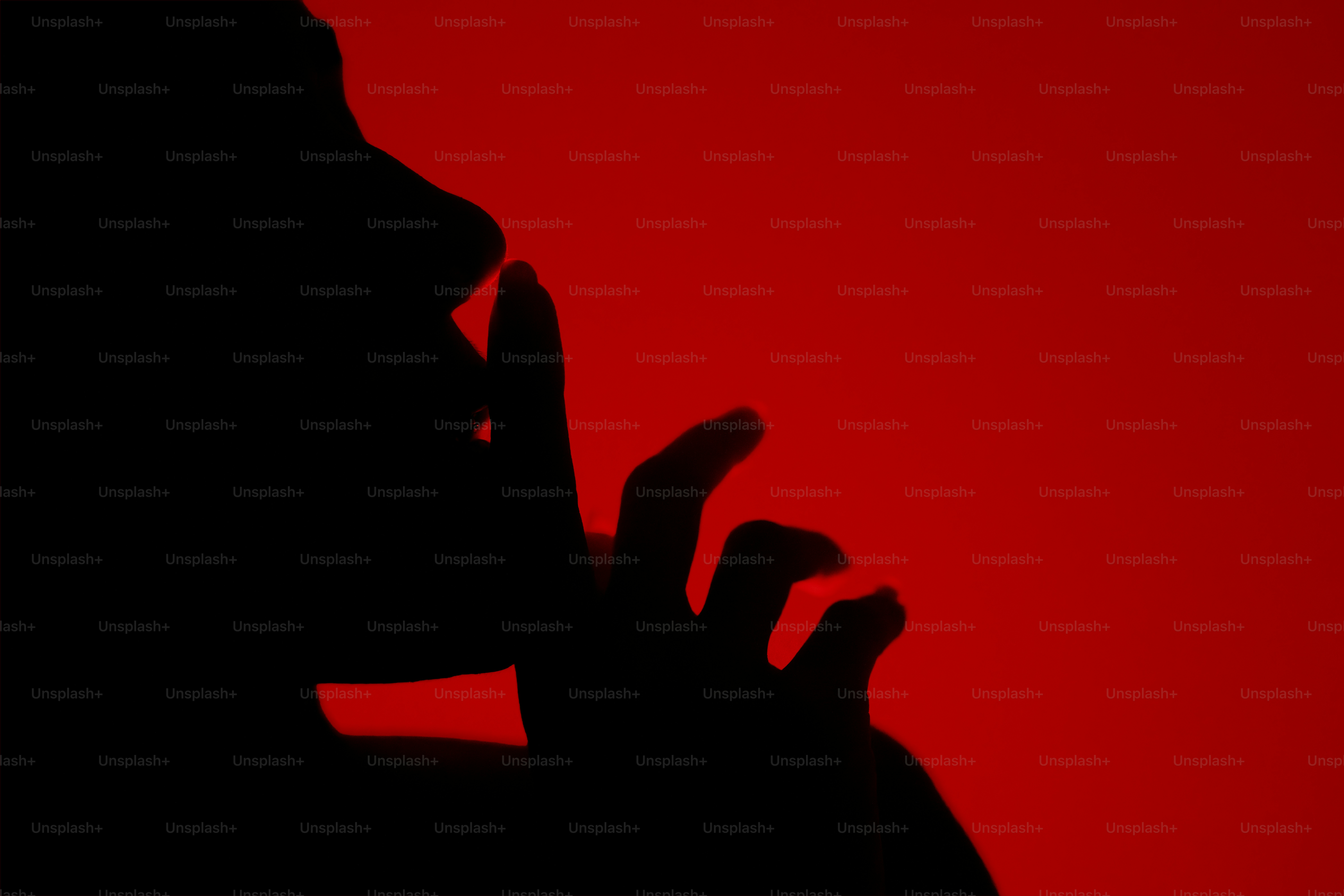 Silhouette of a person making a shushing gesture