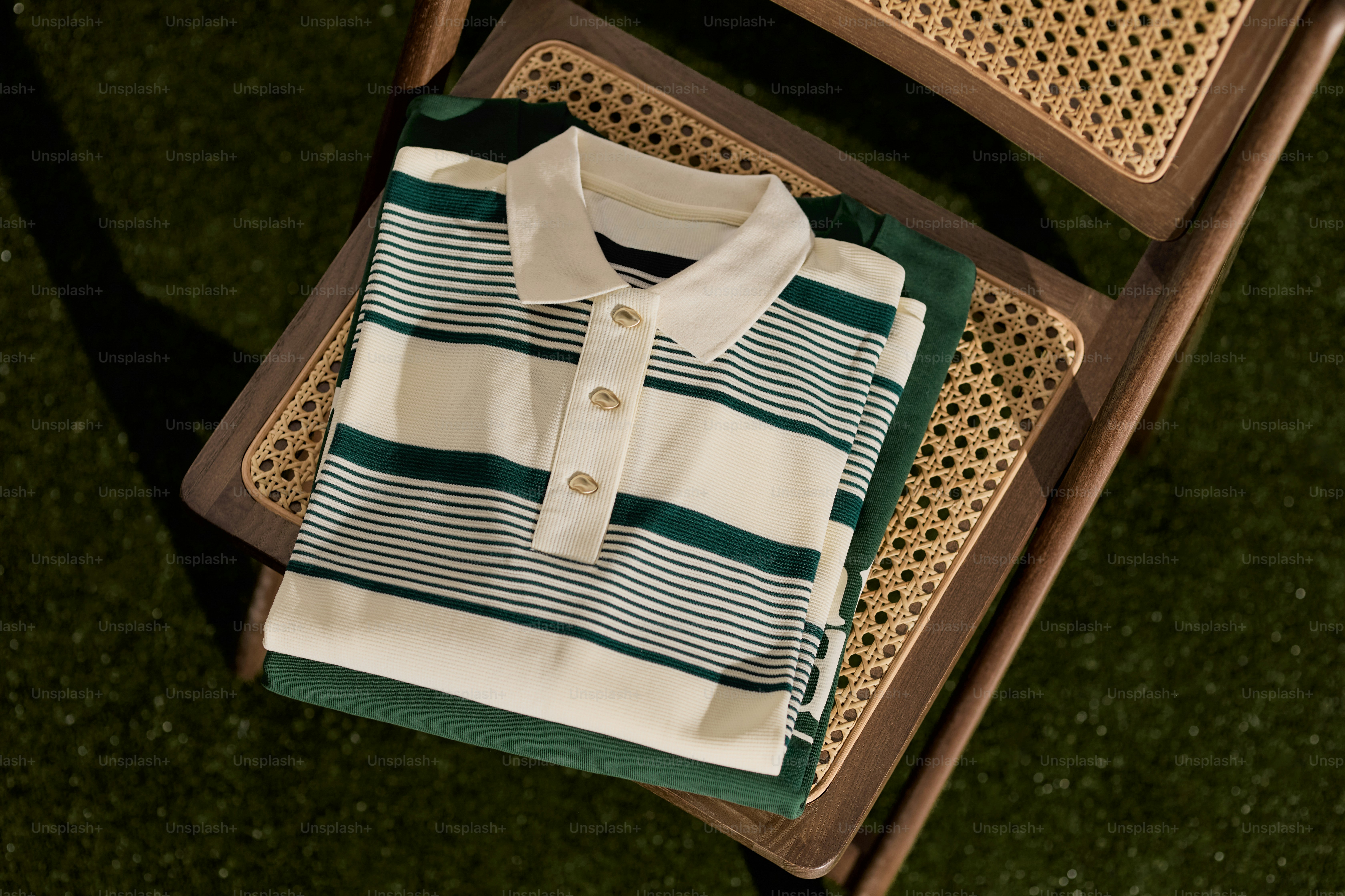 Striped polo shirt folded on a chair