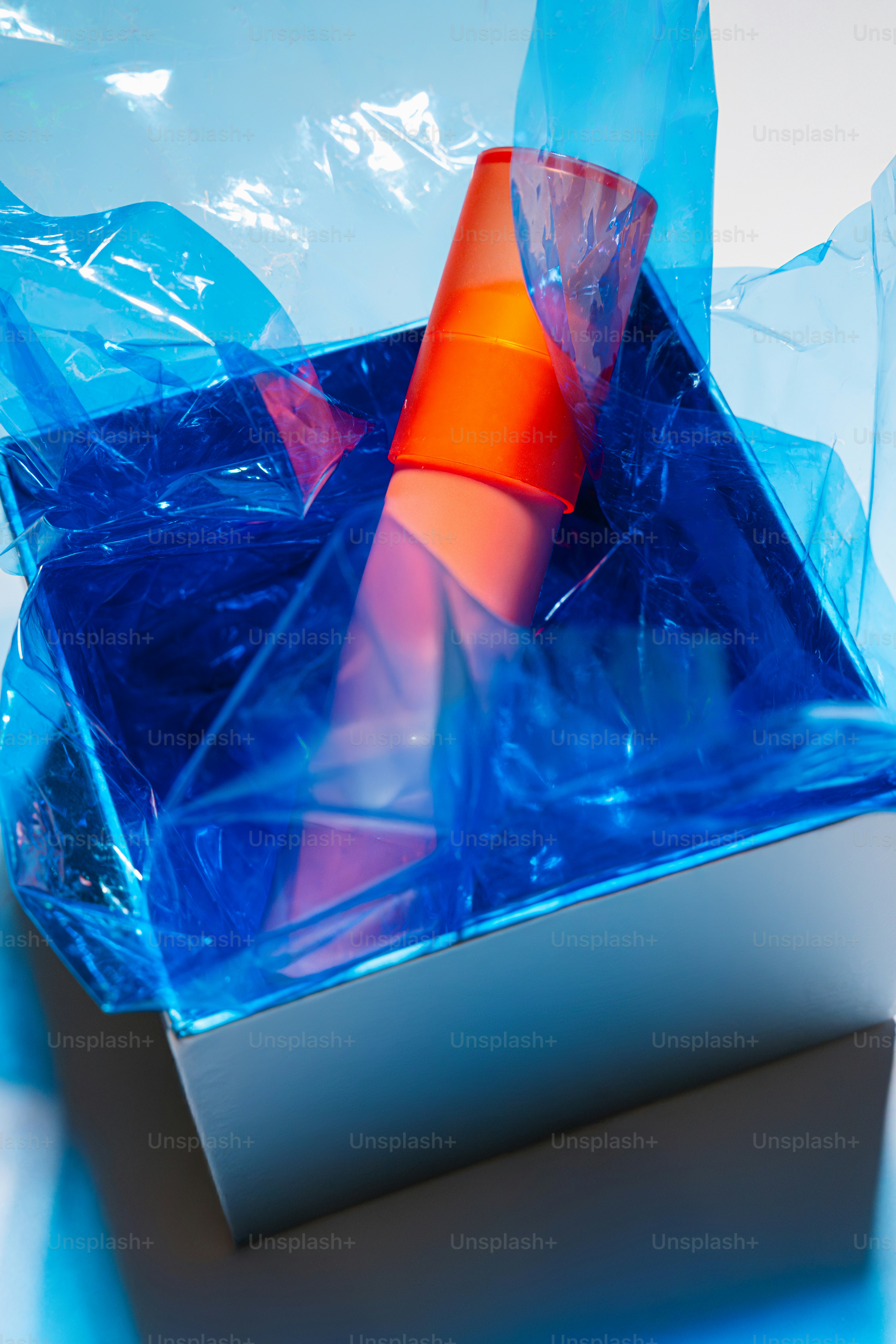 Orange object in a box with blue wrapping. photo – Birthday Image on ...