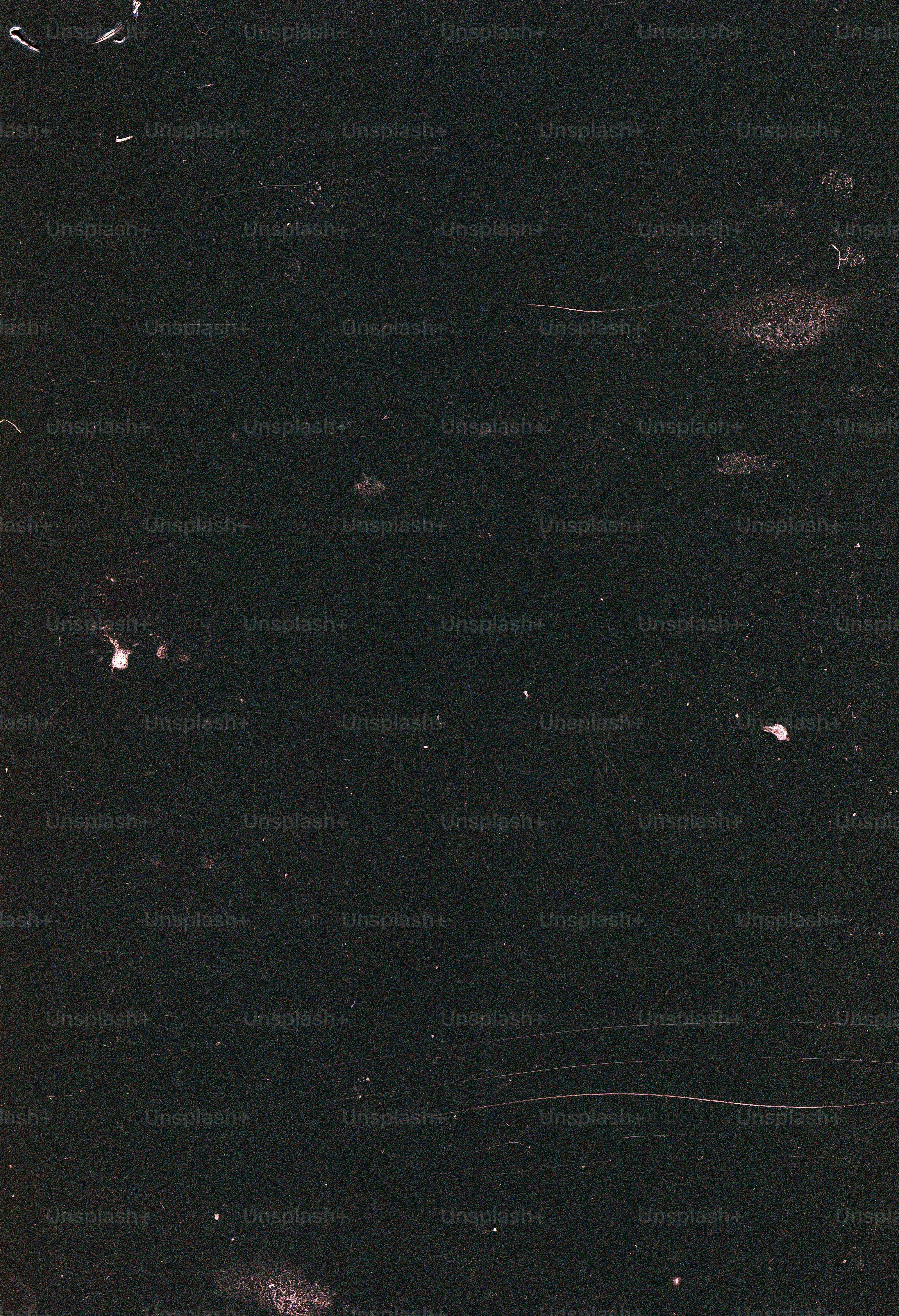 Dark textured background with light speckles and lines