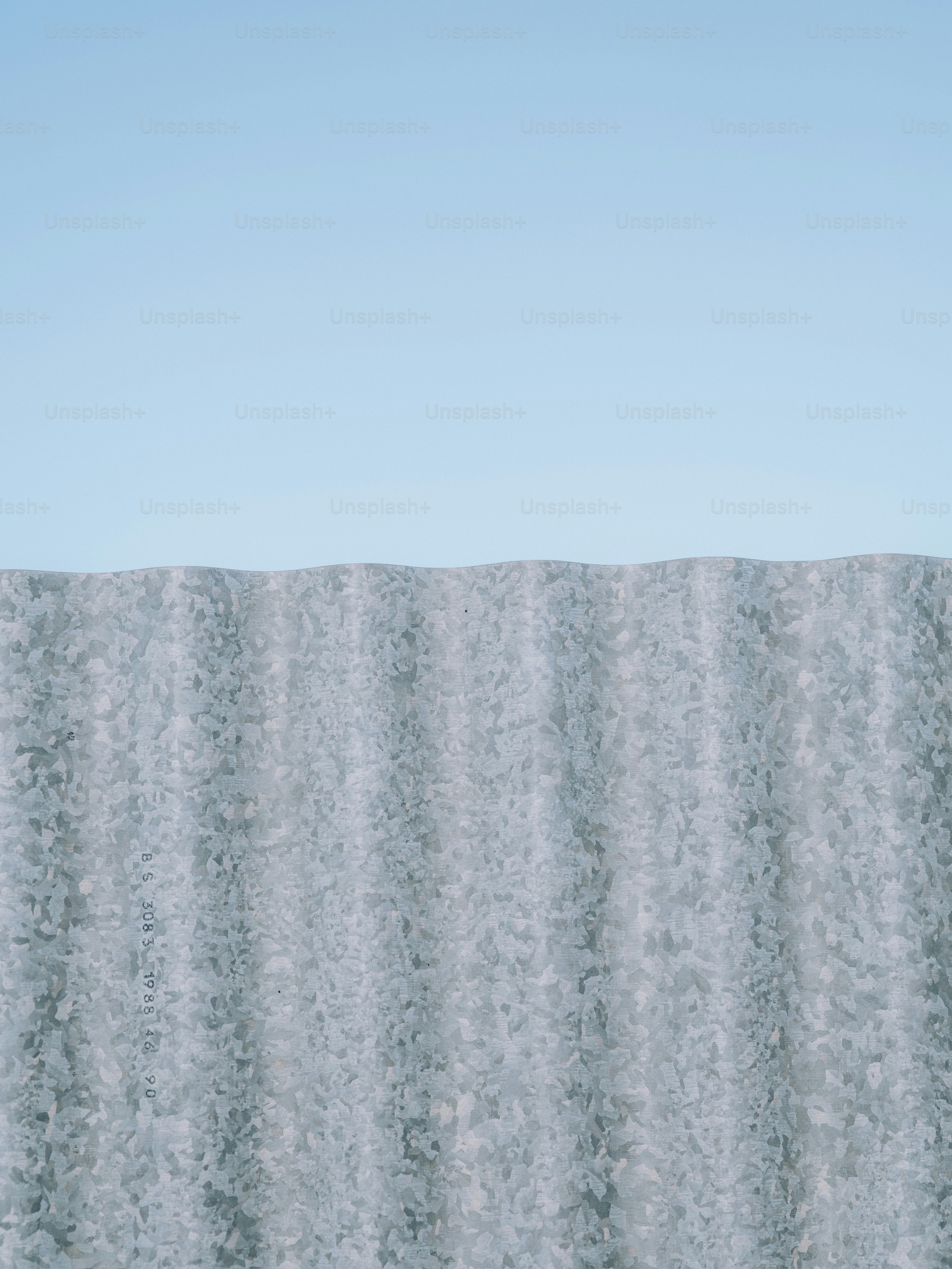 Corrugated metal fence against a clear blue sky