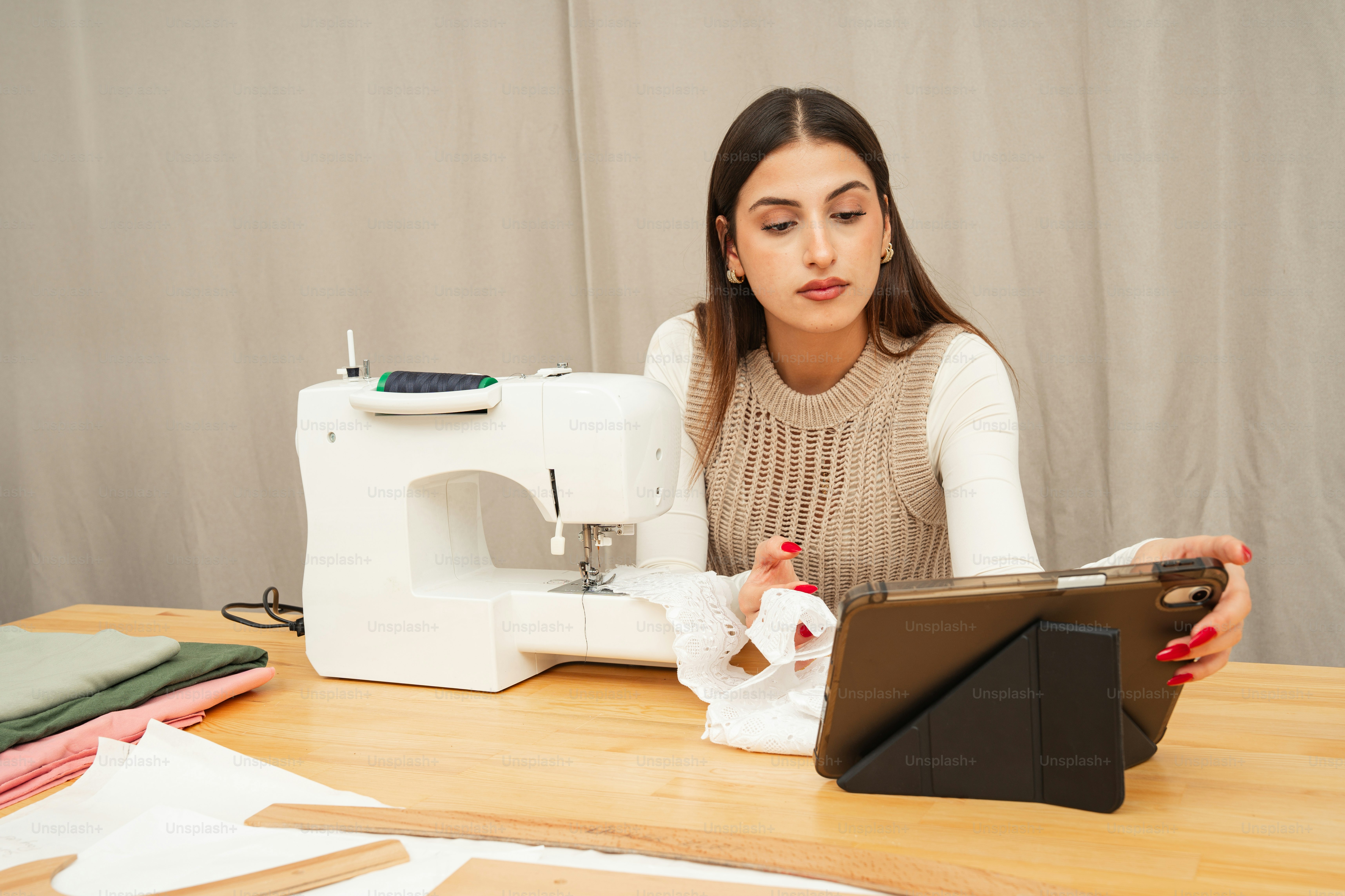 Woman sewing with a machine and tablet photo – Artificial intelligence ...
