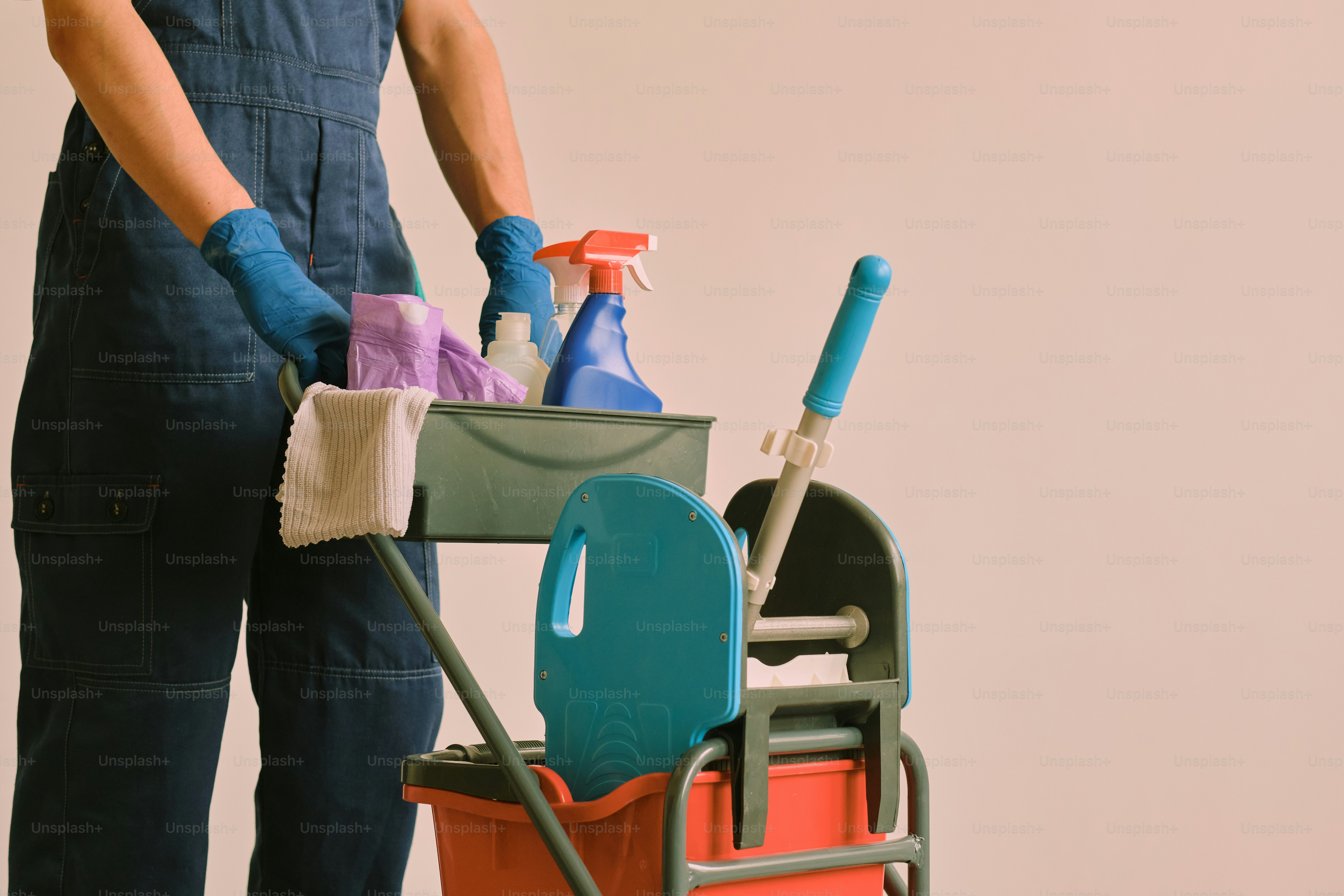 Person with cleaning supplies on a cart