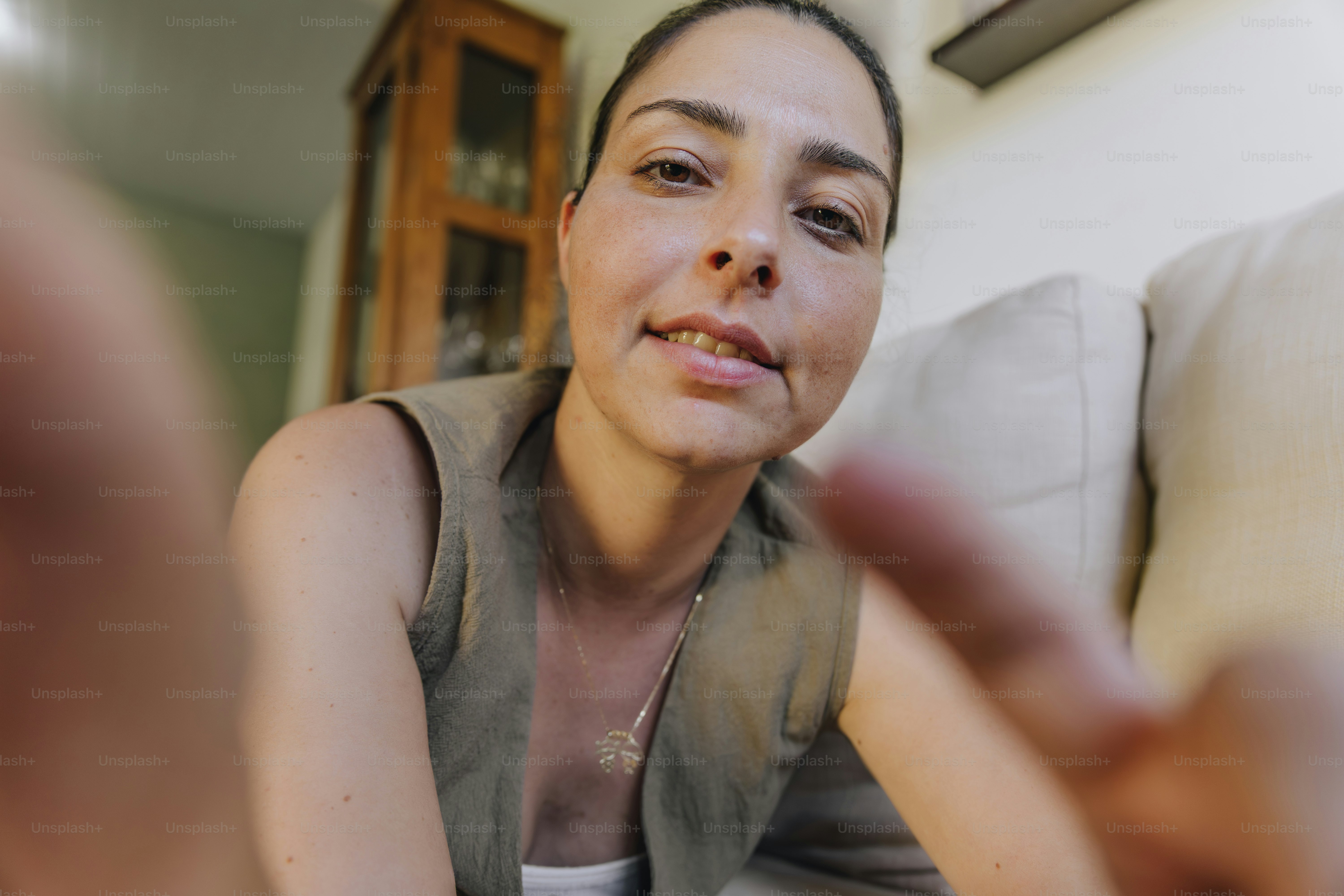 Woman reaching towards camera with finger