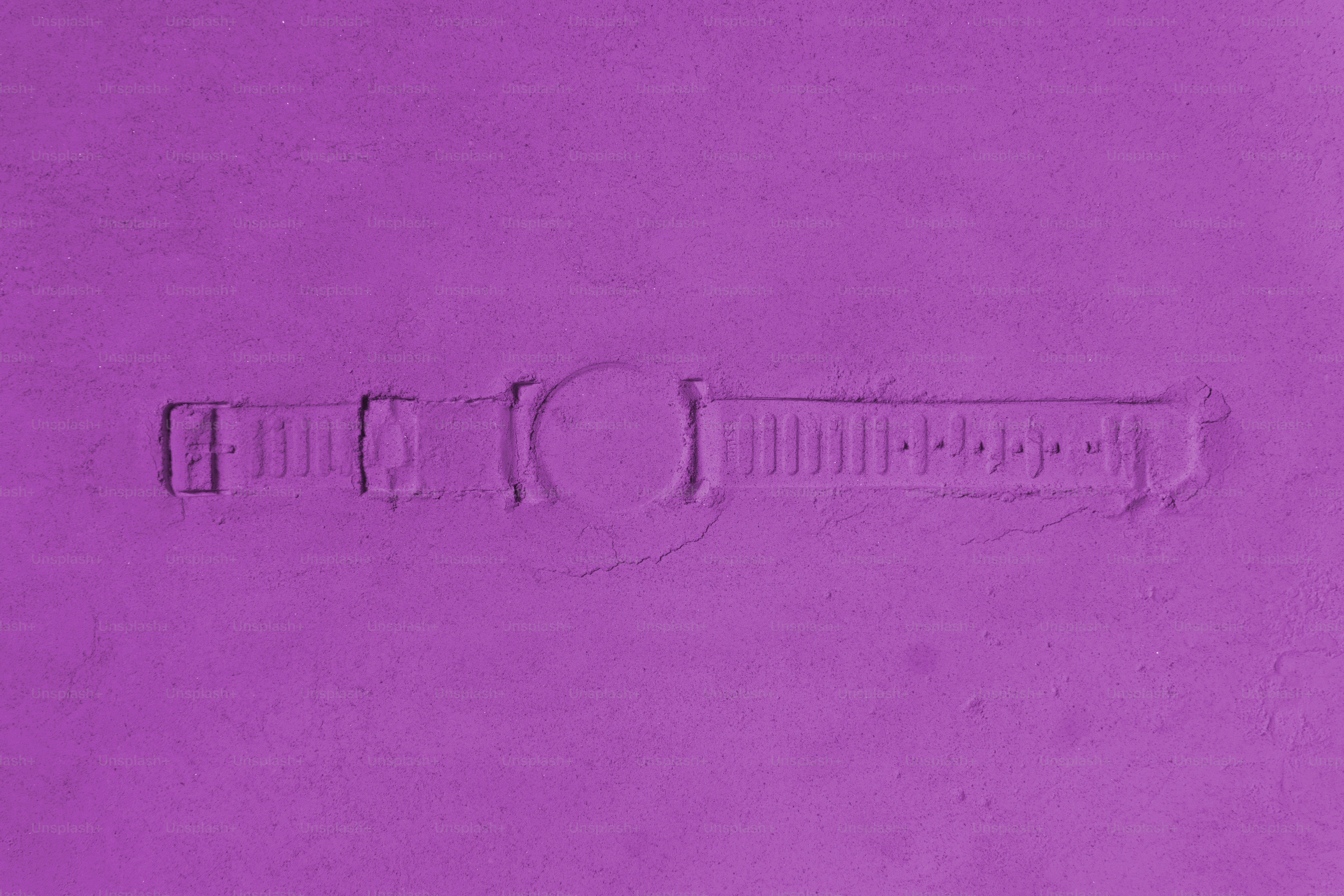 紫色の背景にデボス加工された時計のデザイン。