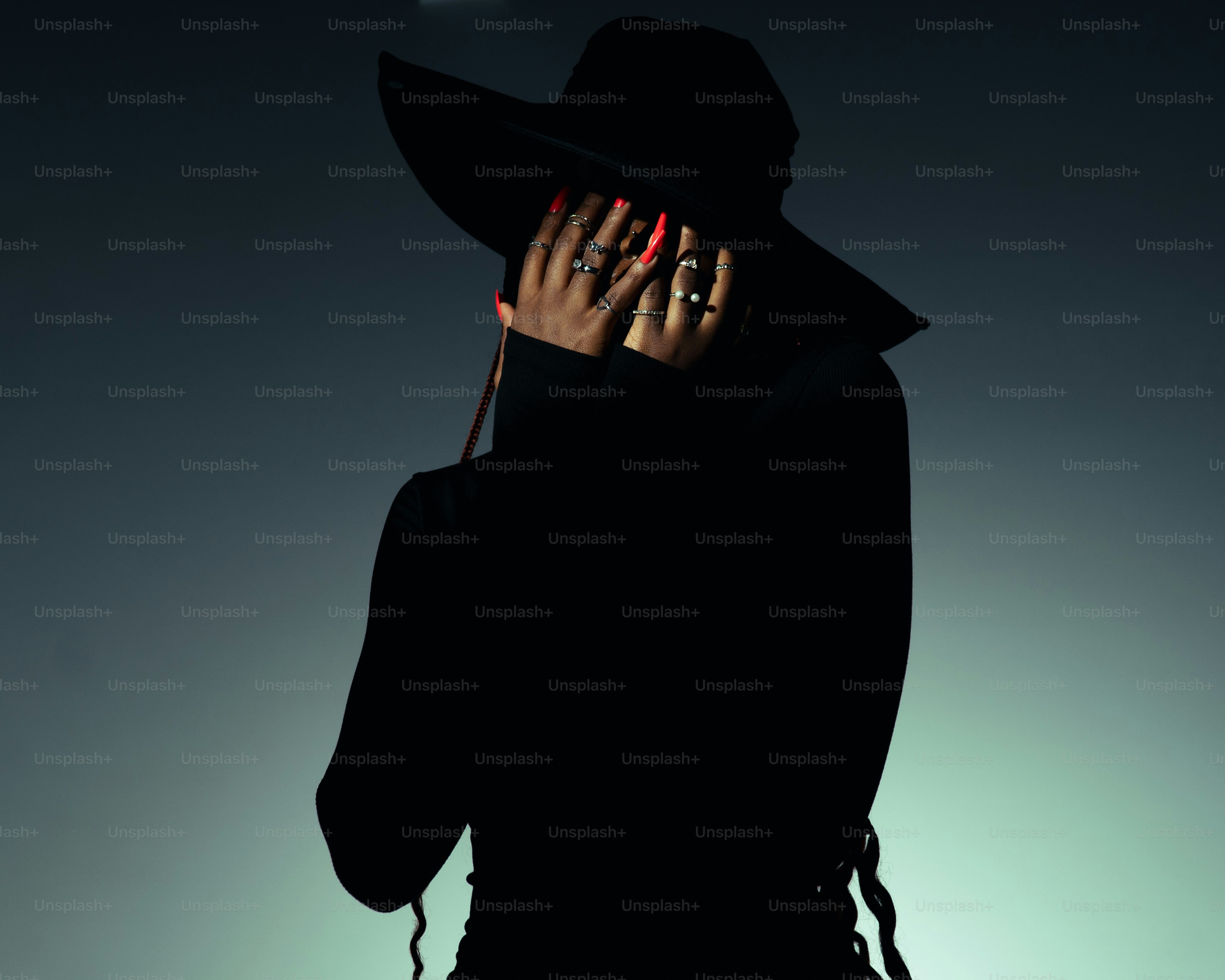 Mujer con sombrero negro se cubre la cara con las manos