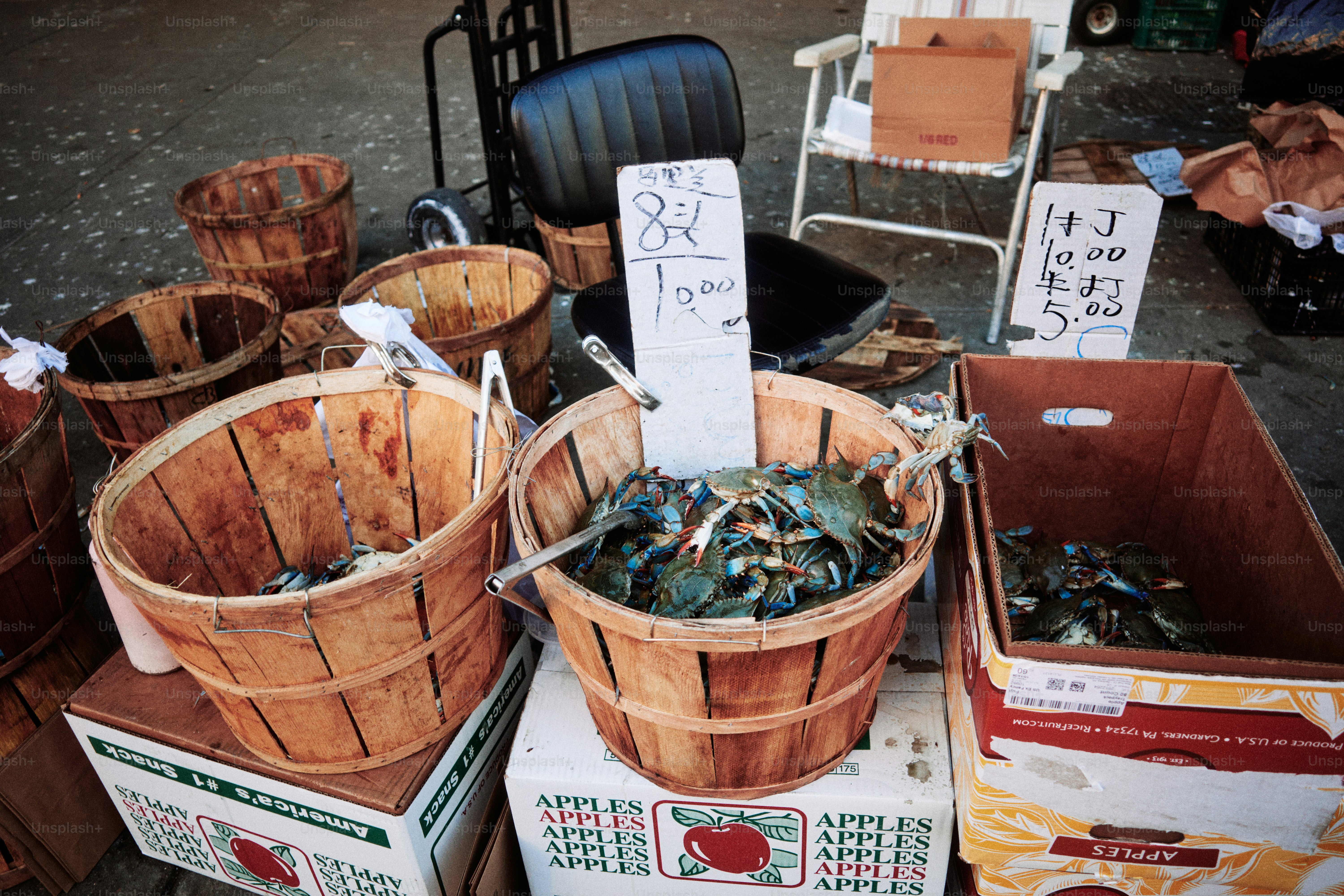 Fresh crabs in wooden baskets at a market.