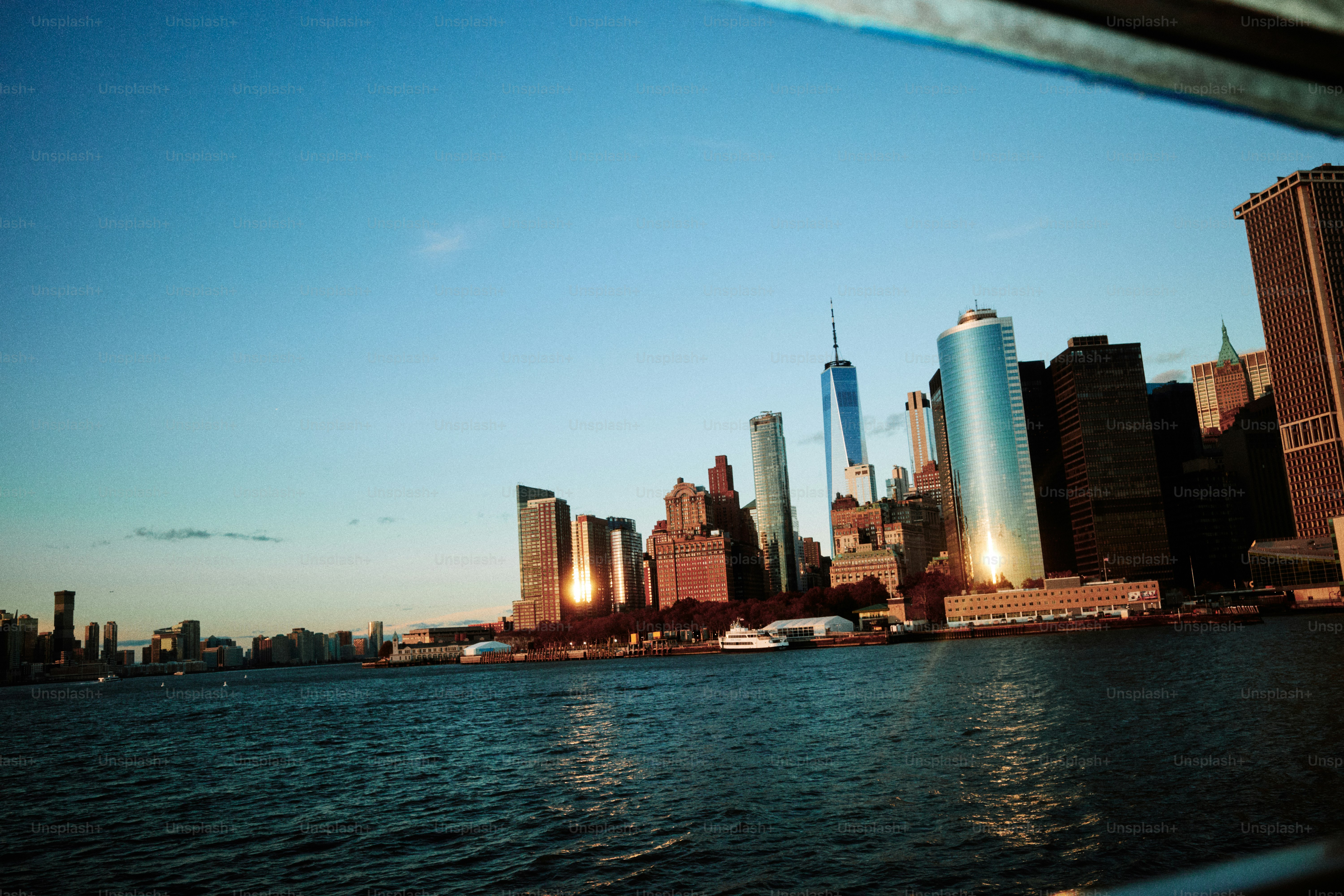 New york city skyline at sunset over the water. photo – Sea Image on ...