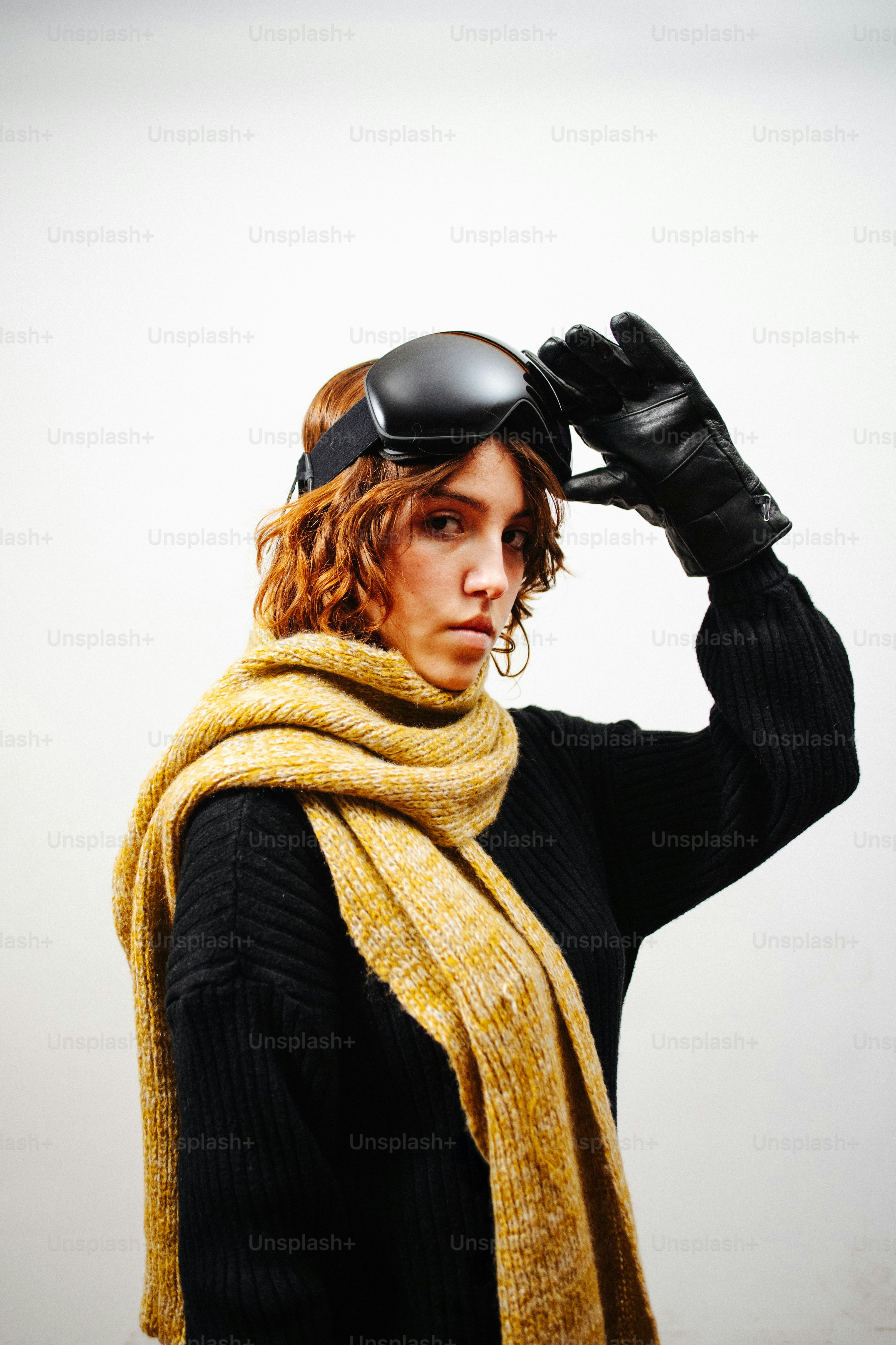 Woman wearing ski goggles and a yellow scarf