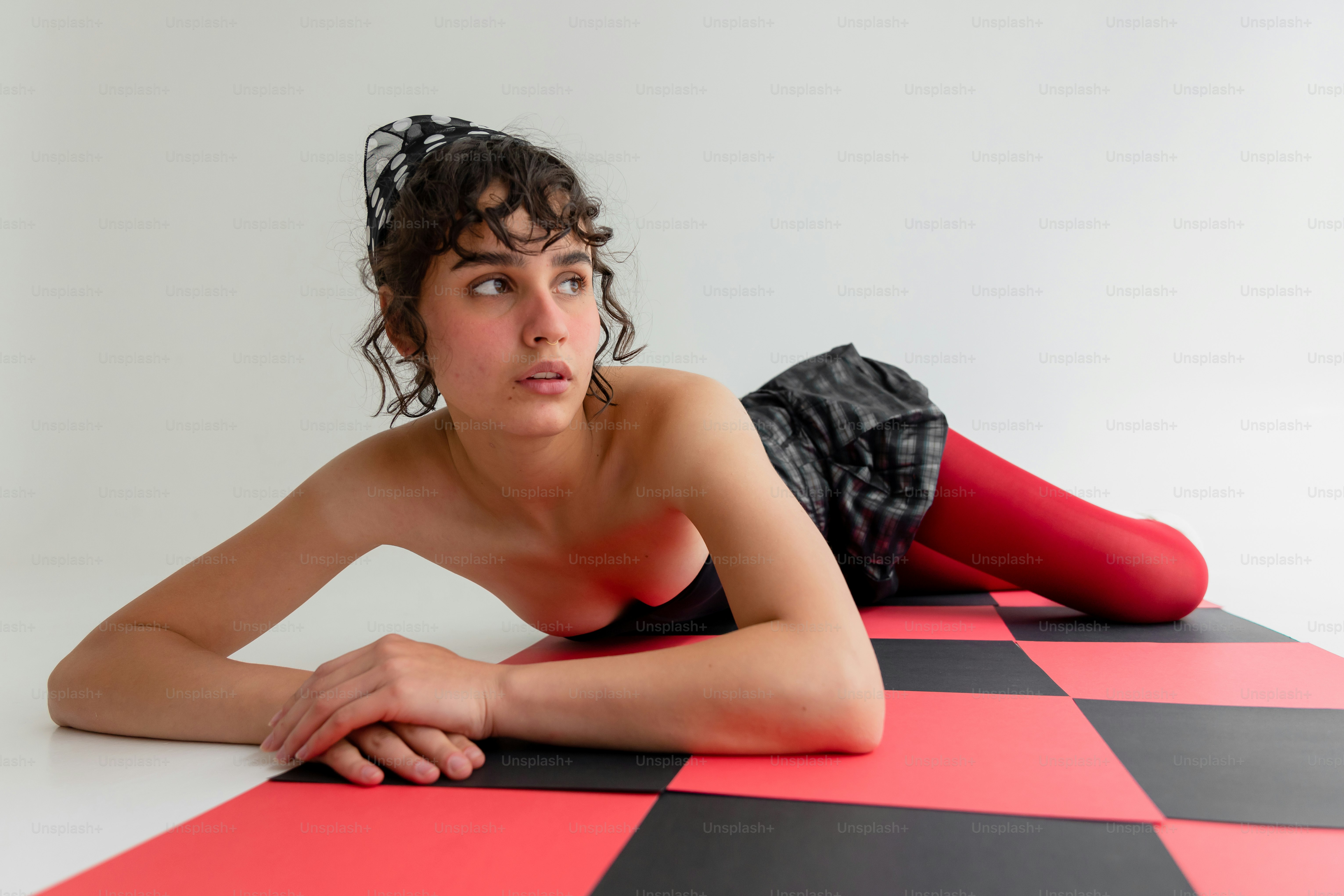 Woman in red tights on checkerboard floor