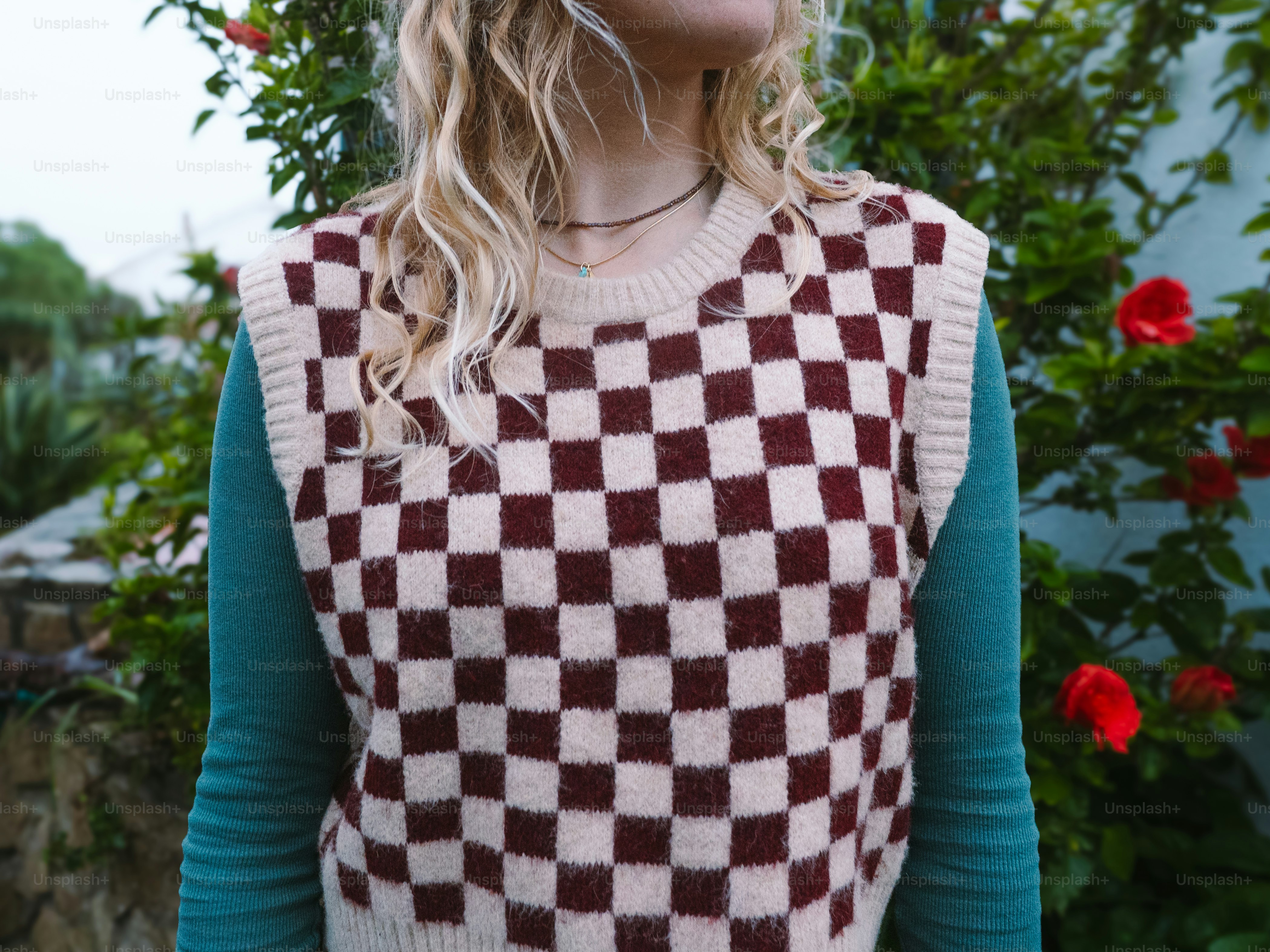 Woman wearing a checkered sweater vest outdoors. photo – Fashion Image ...