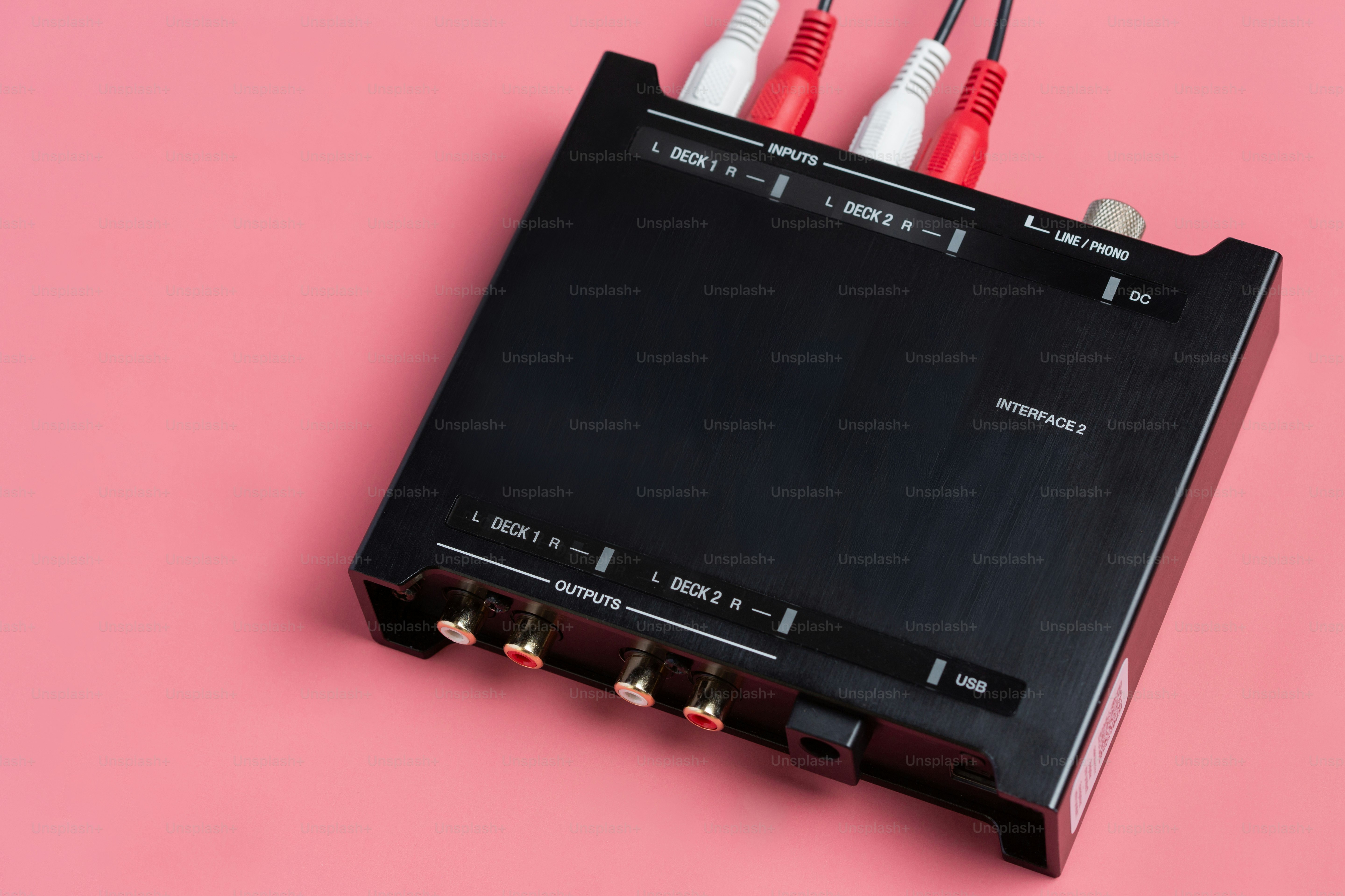 Black audio interface with red and white cables