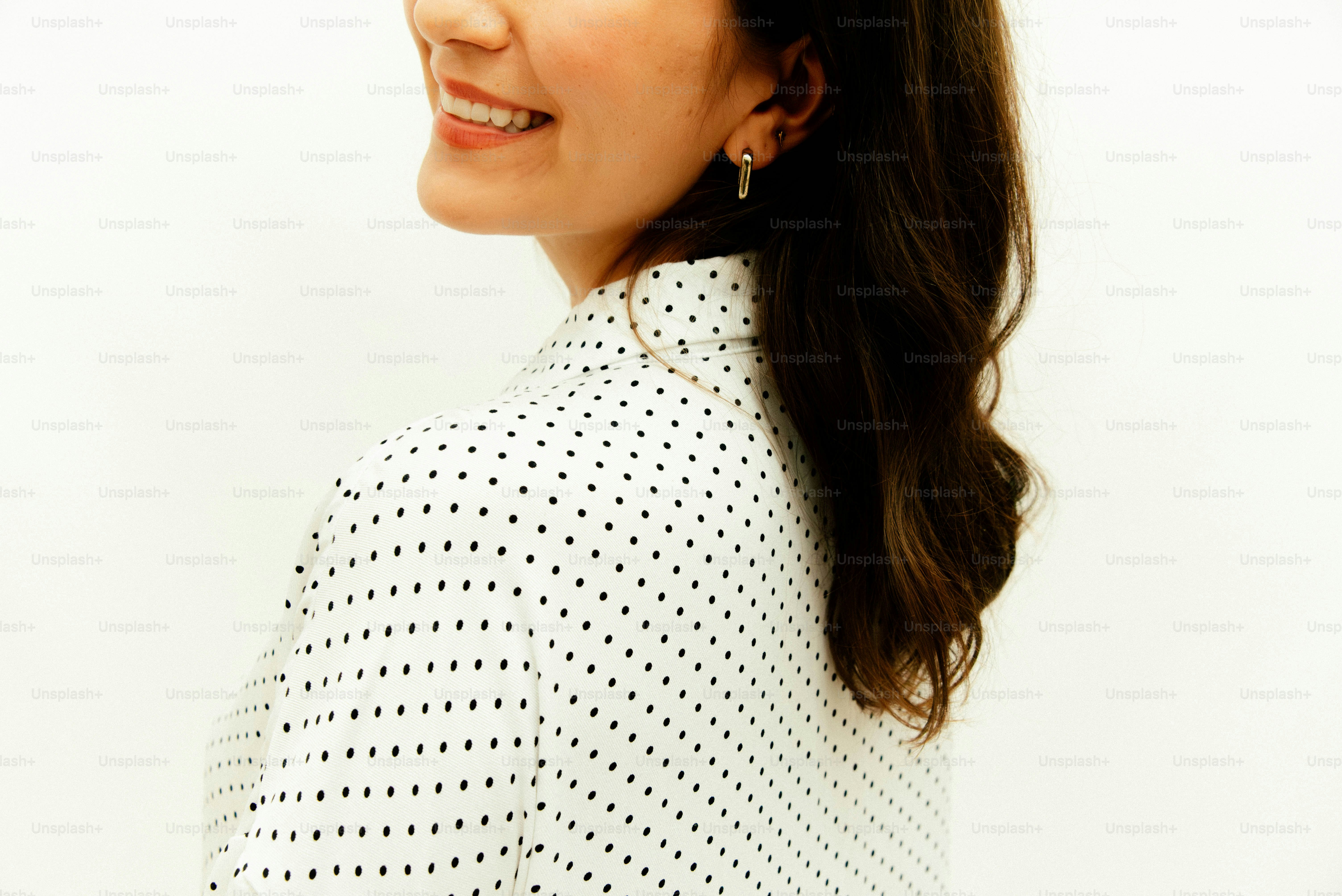 Woman in polka dot shirt smiling