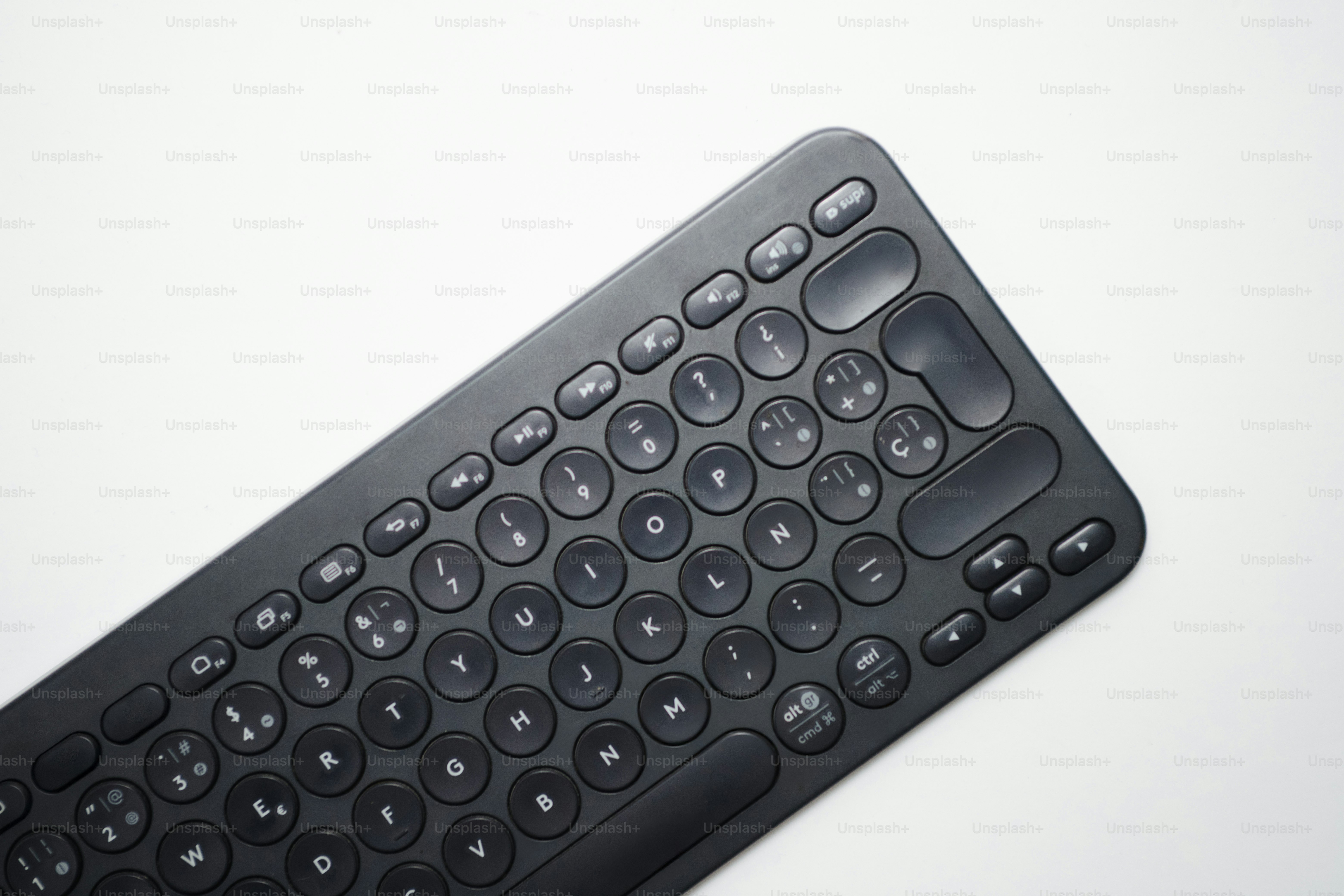 A black wireless keyboard on a white background