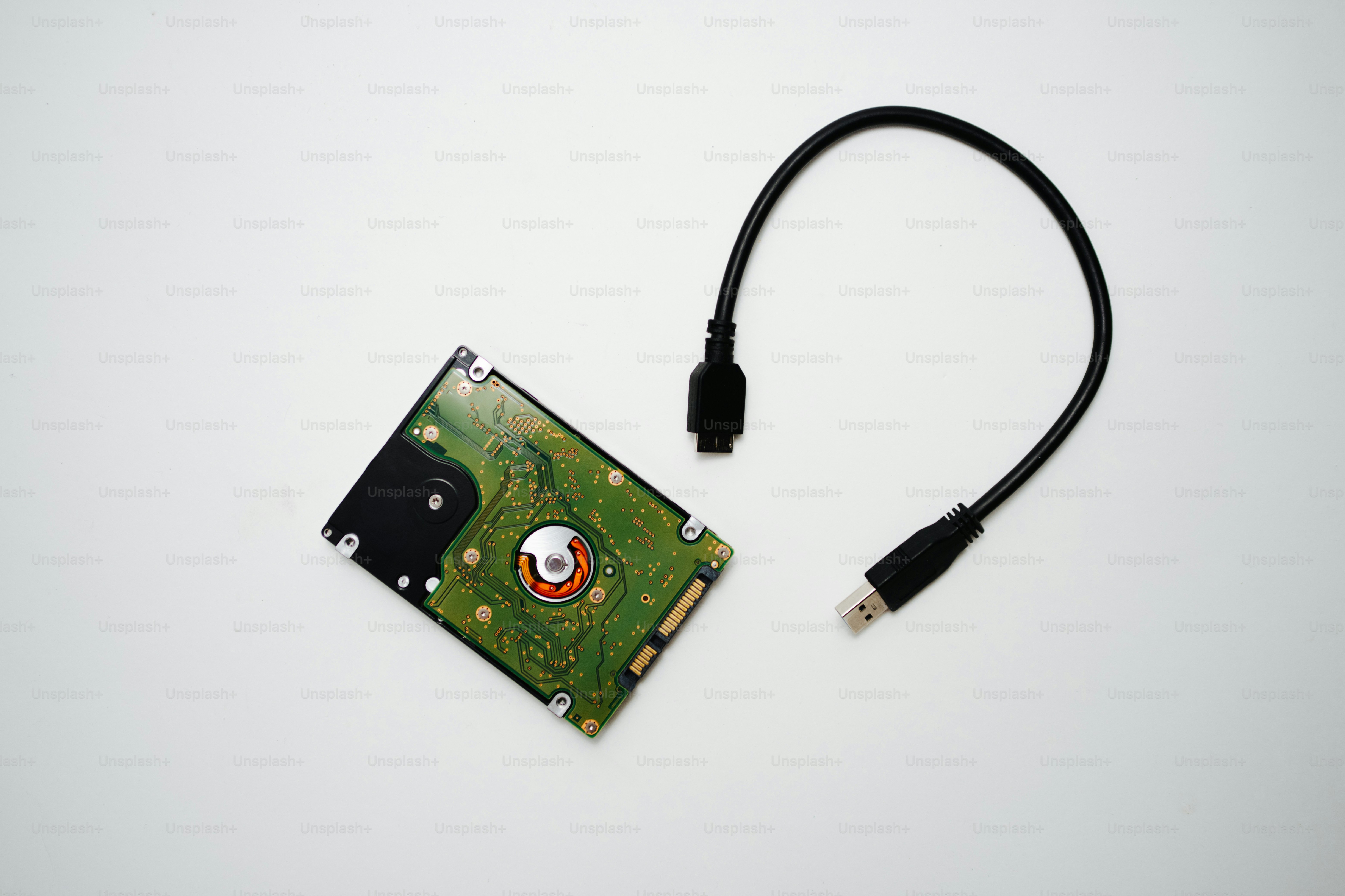 Hard drive with usb adapter cable on white background