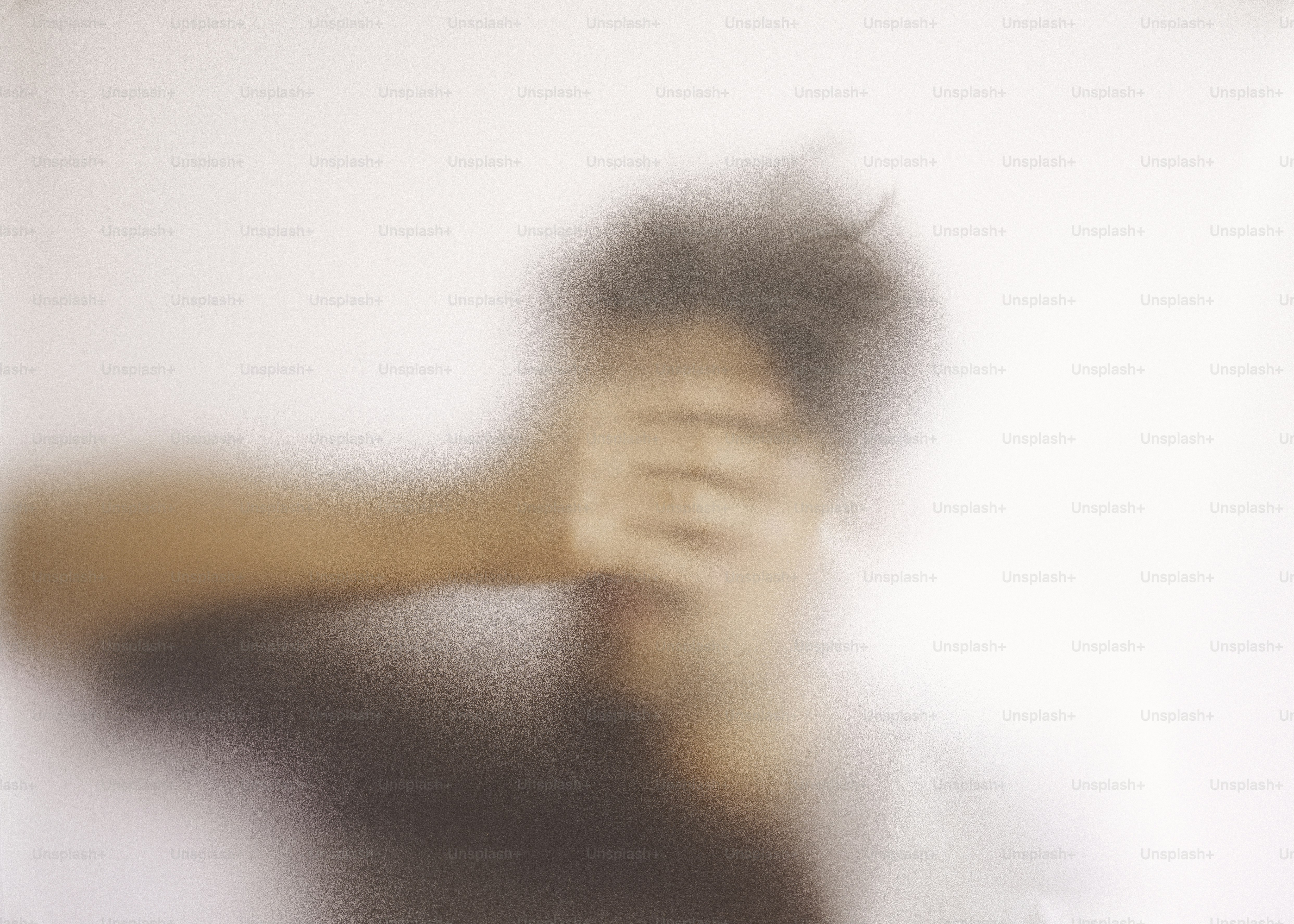 Person covering face with hand, blurred background. photo – Shadow ...