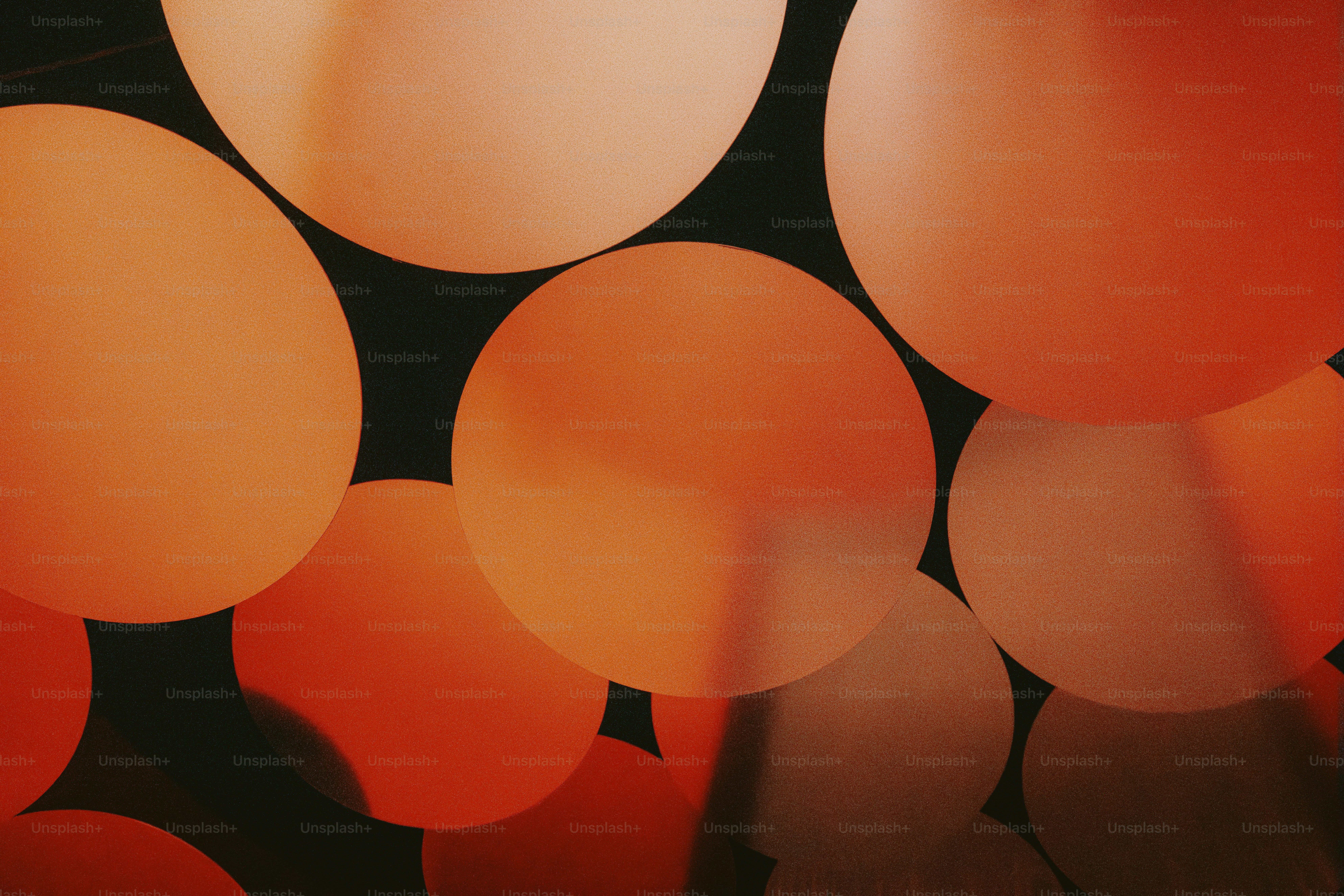 Close-up of illuminated orange spheres against dark background