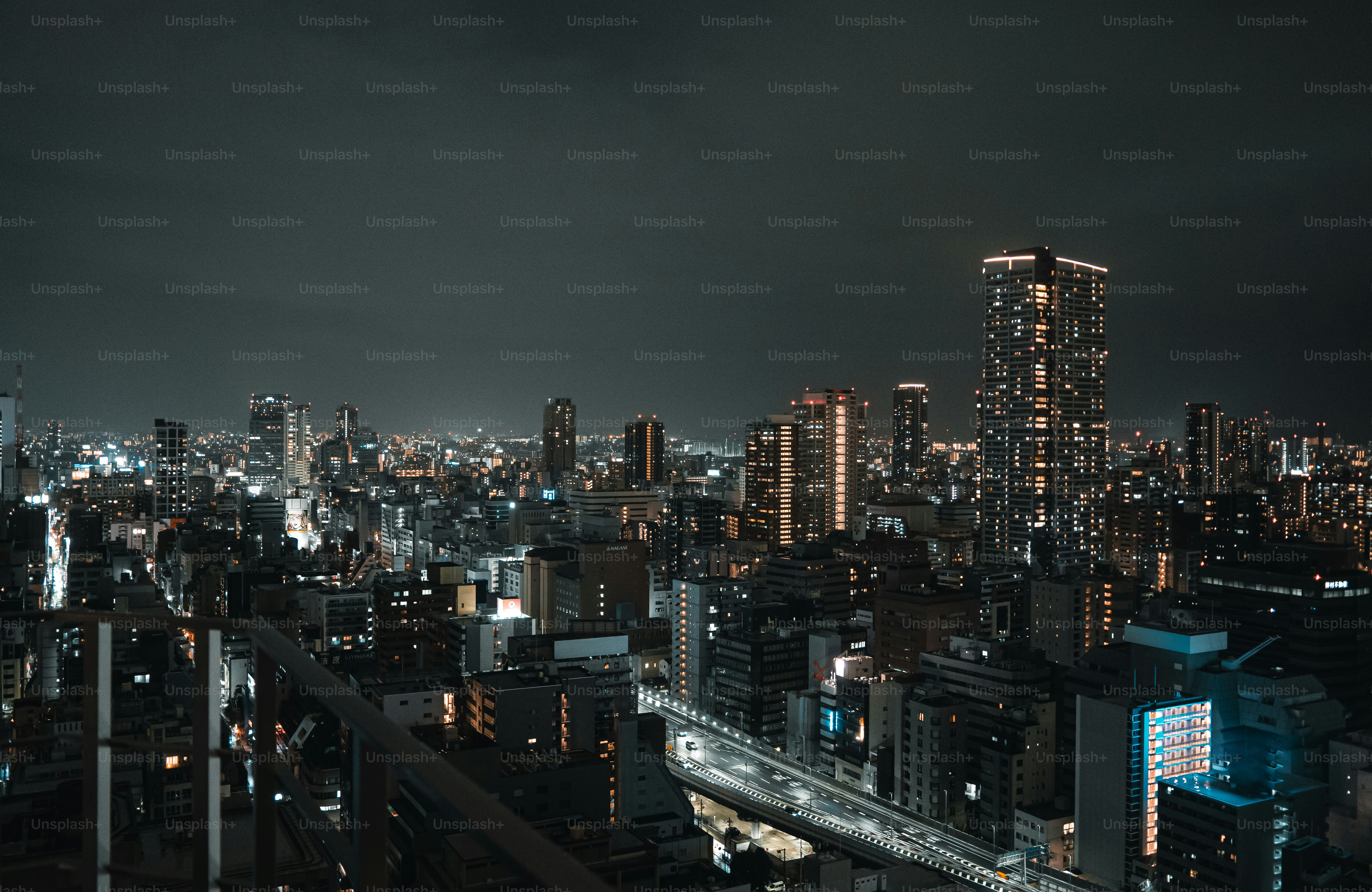 A sprawling cityscape illuminated at night under a dark sky.