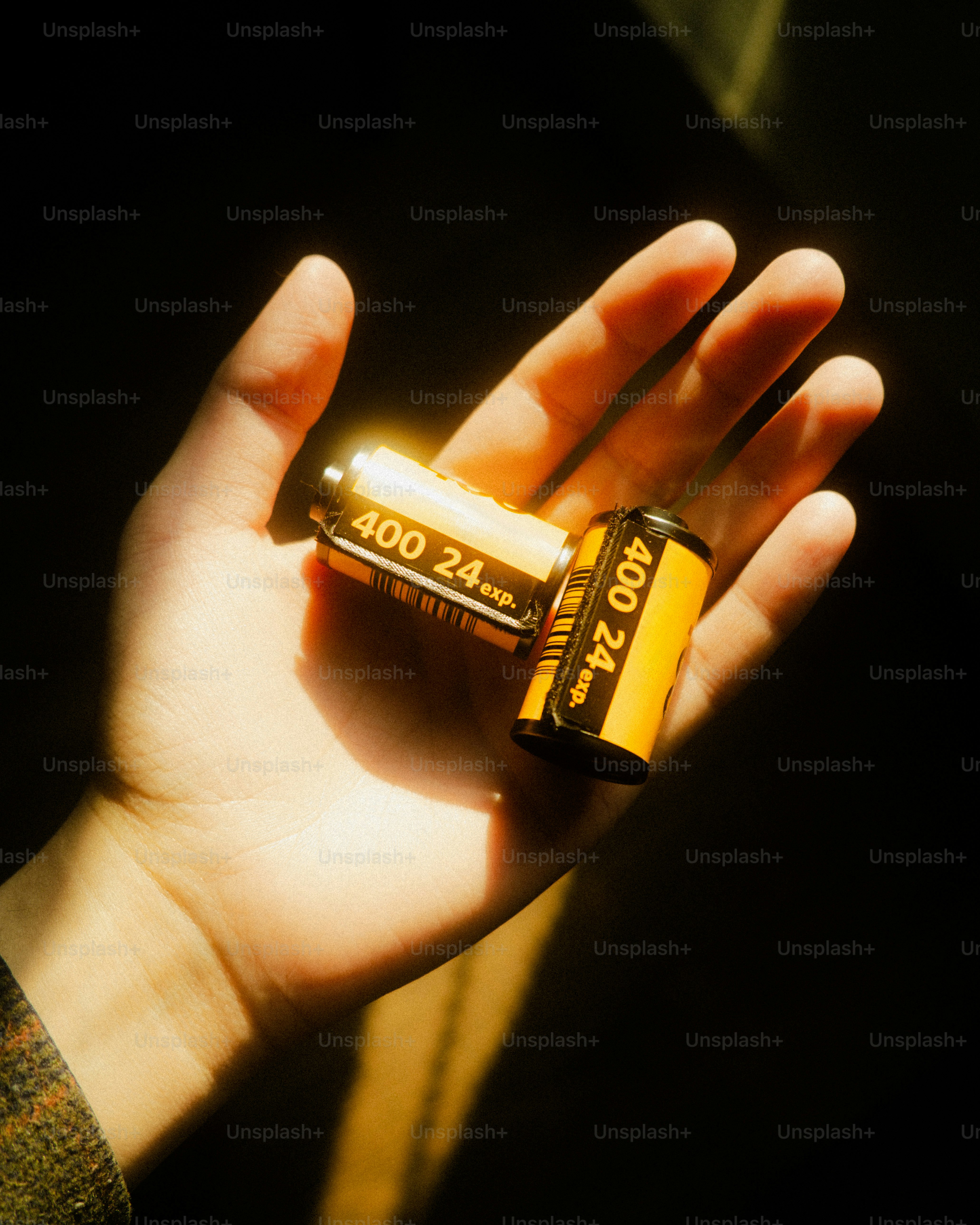 Two rolls of film held in a hand.