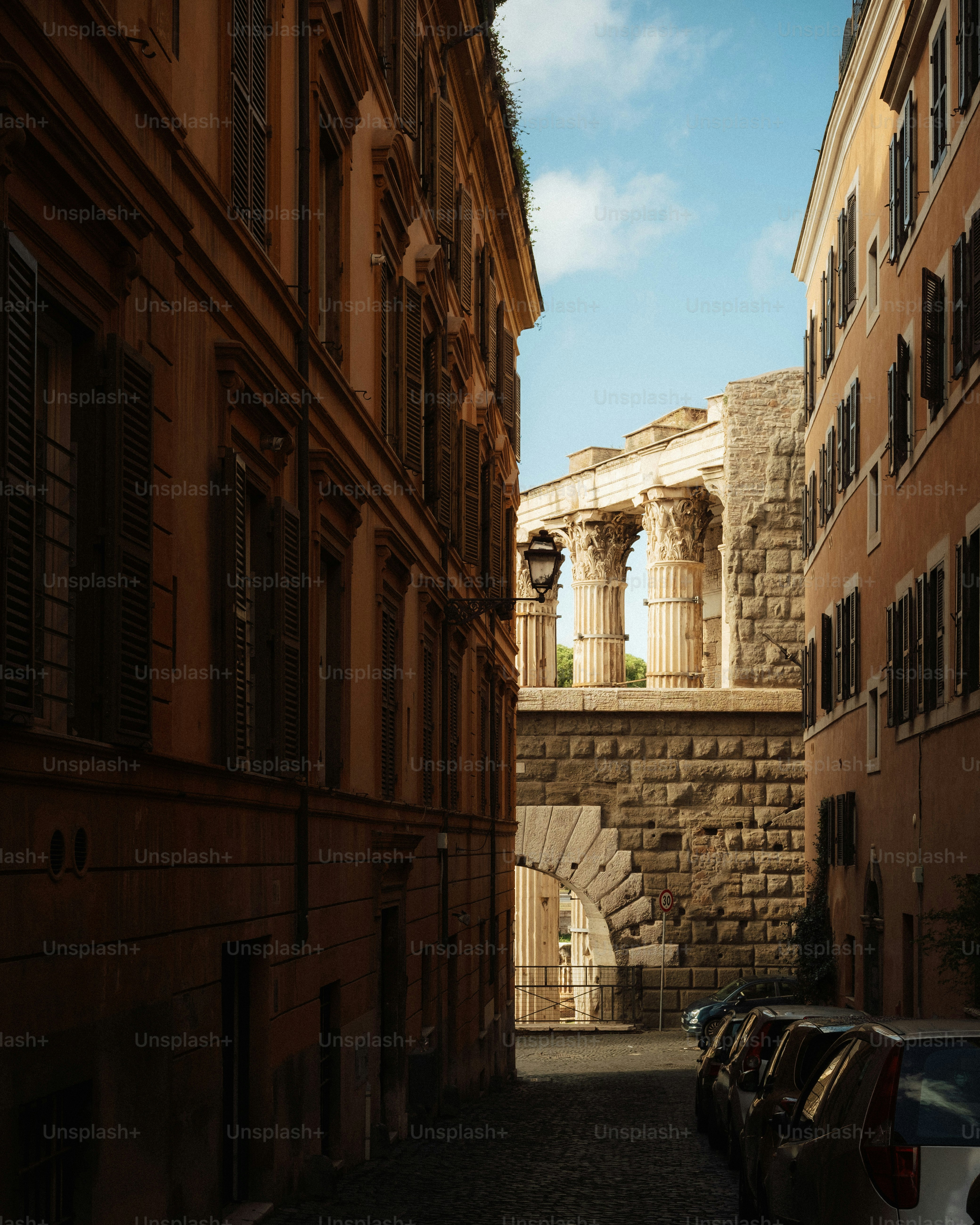 Ancient roman temple ruins seen from a narrow street