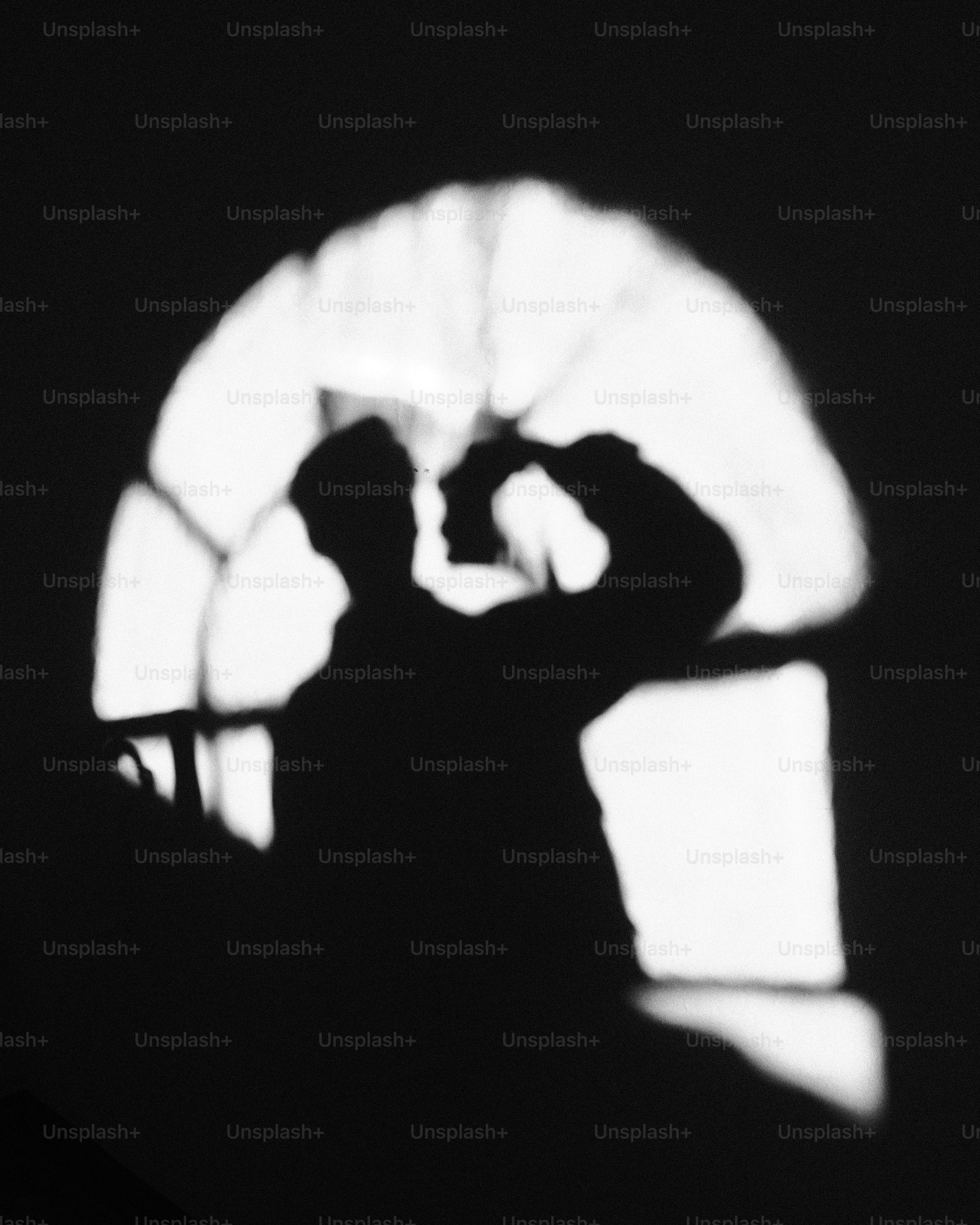 Shadows of two people against a window