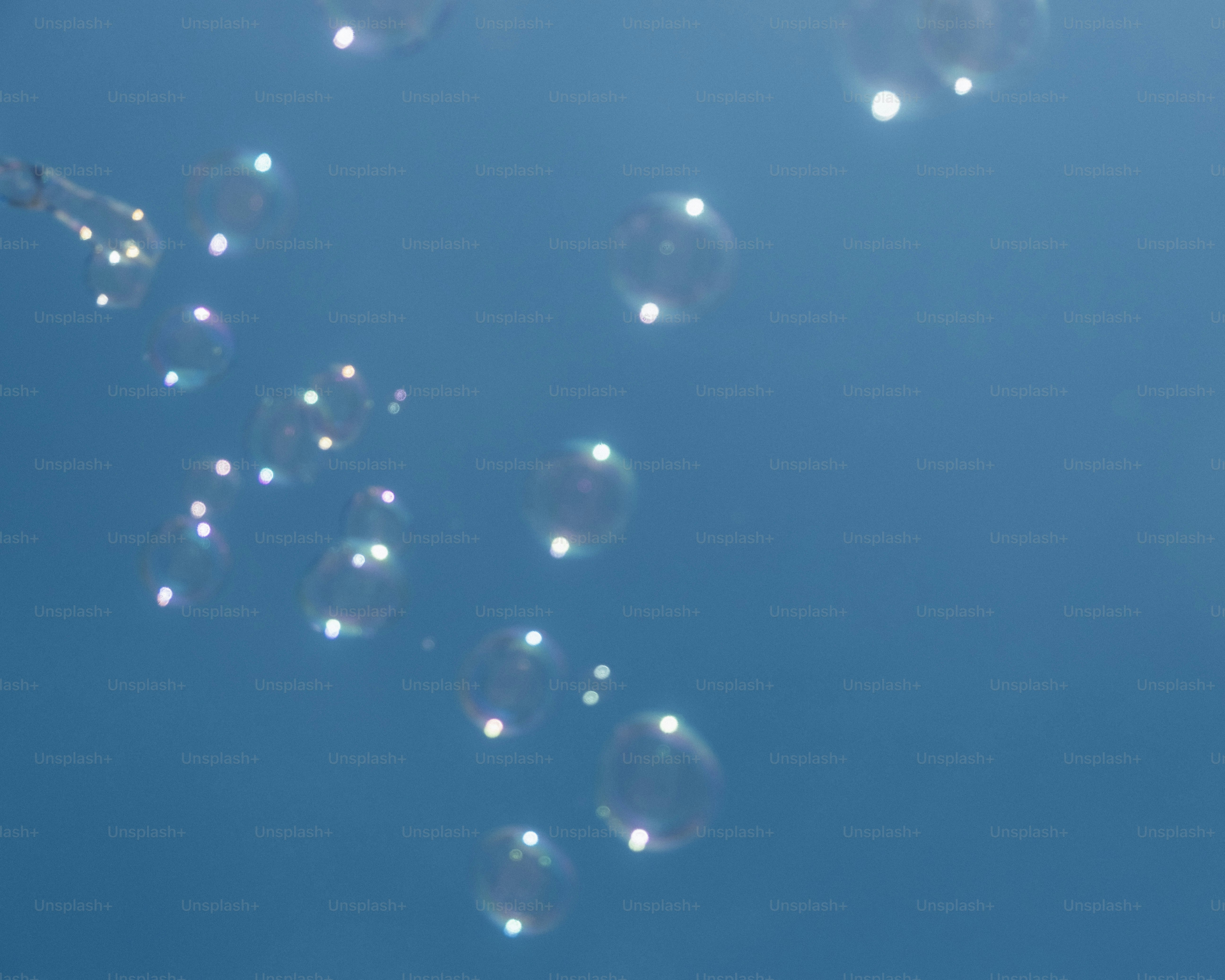 Bubbles floating against a clear blue sky.