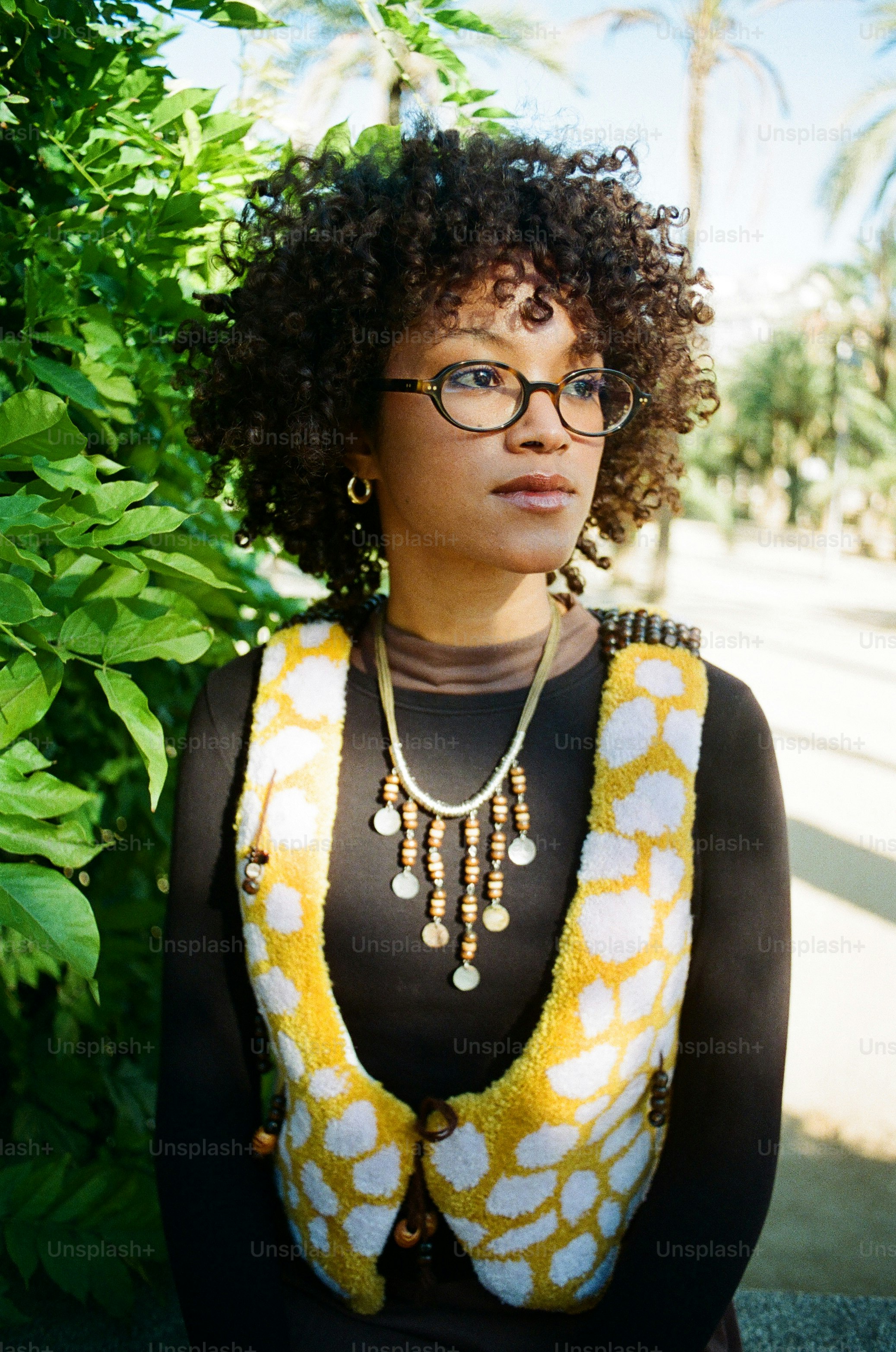 A woman with curly hair and glasses wearing glasses. photo – Model ...