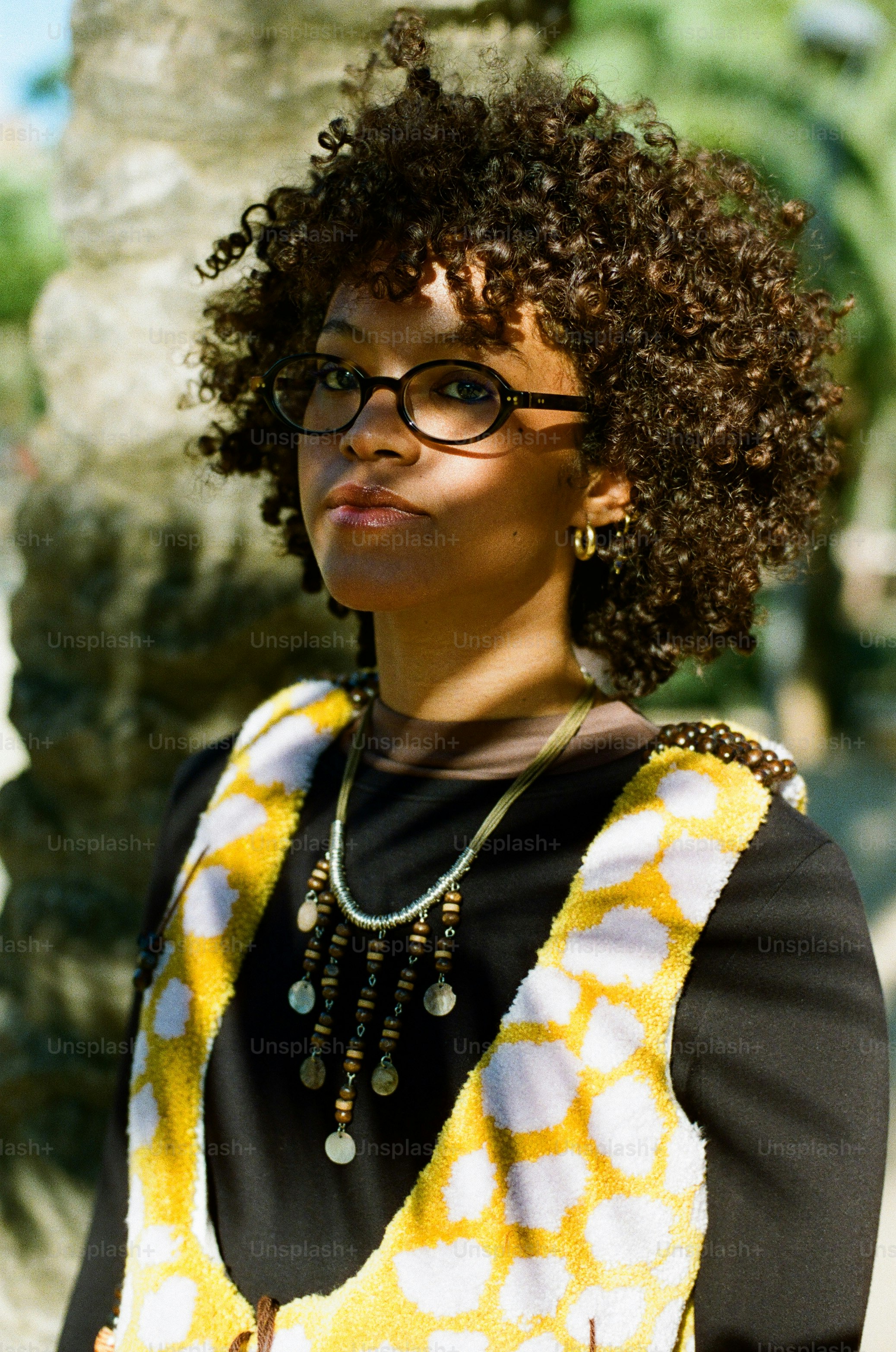 A woman with curly hair and glasses wearing glasses. photo – Model ...