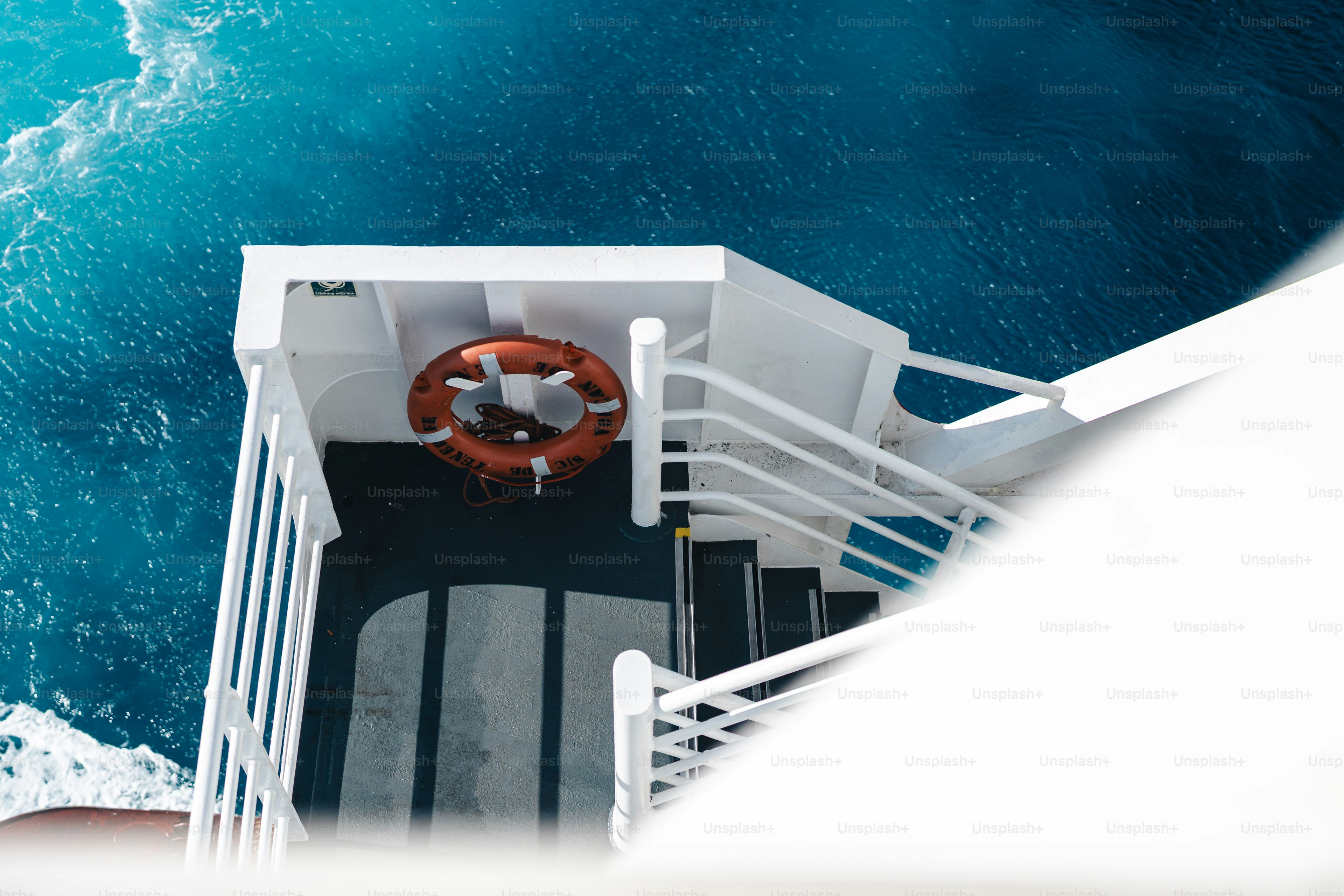 Staircase on a ship deck overlooking blue ocean