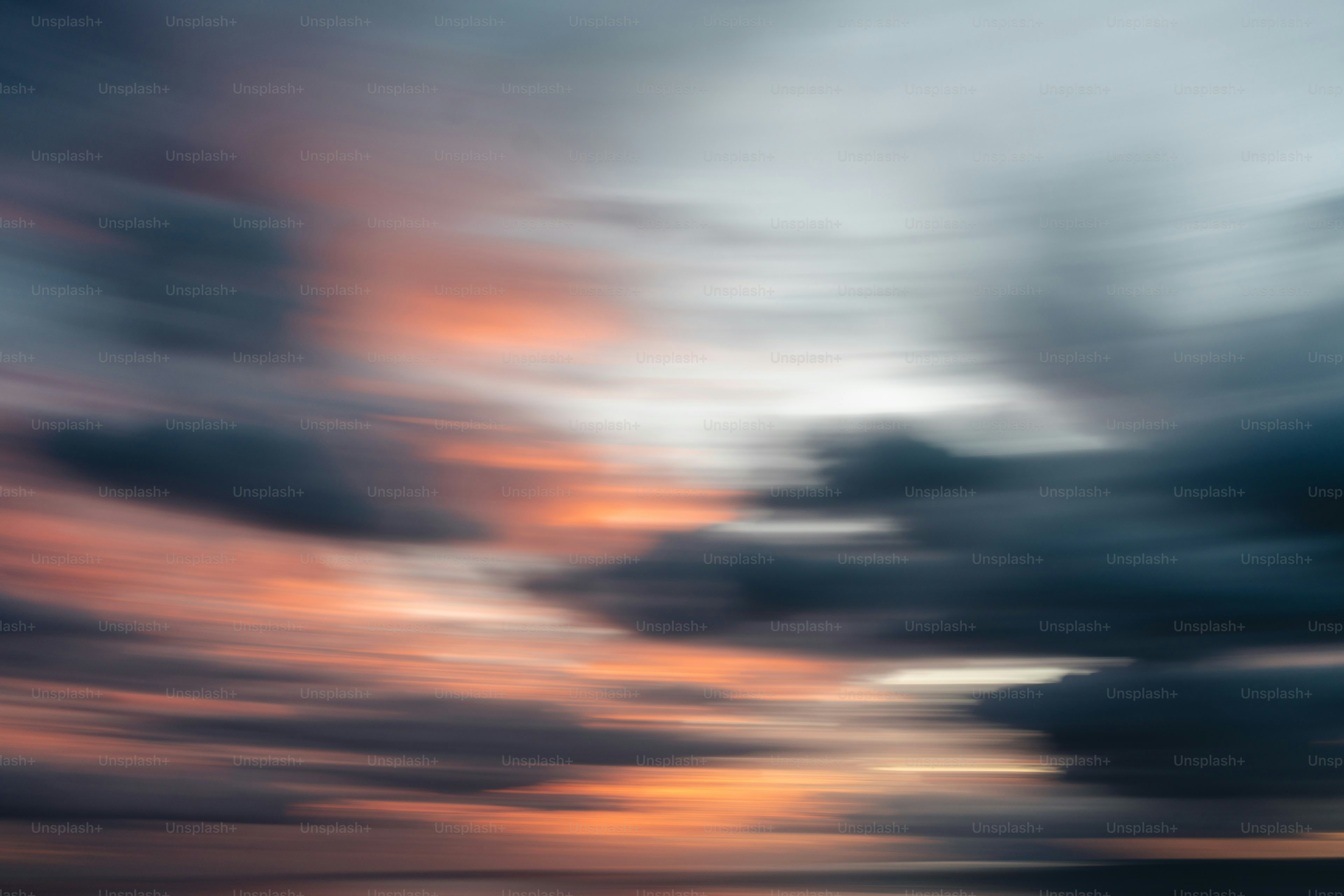 Abstract sunset clouds with streaks of orange and grey photo – Sunset ...