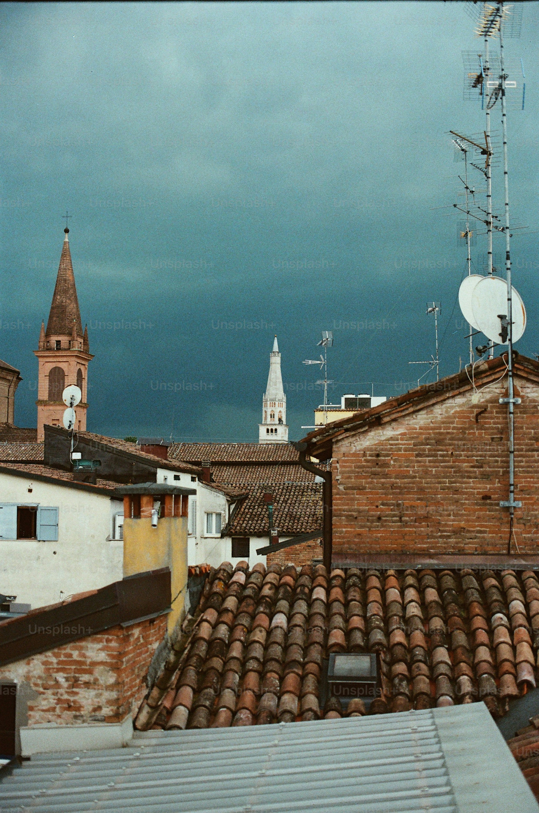 Rooftops and spires under a stormy sky