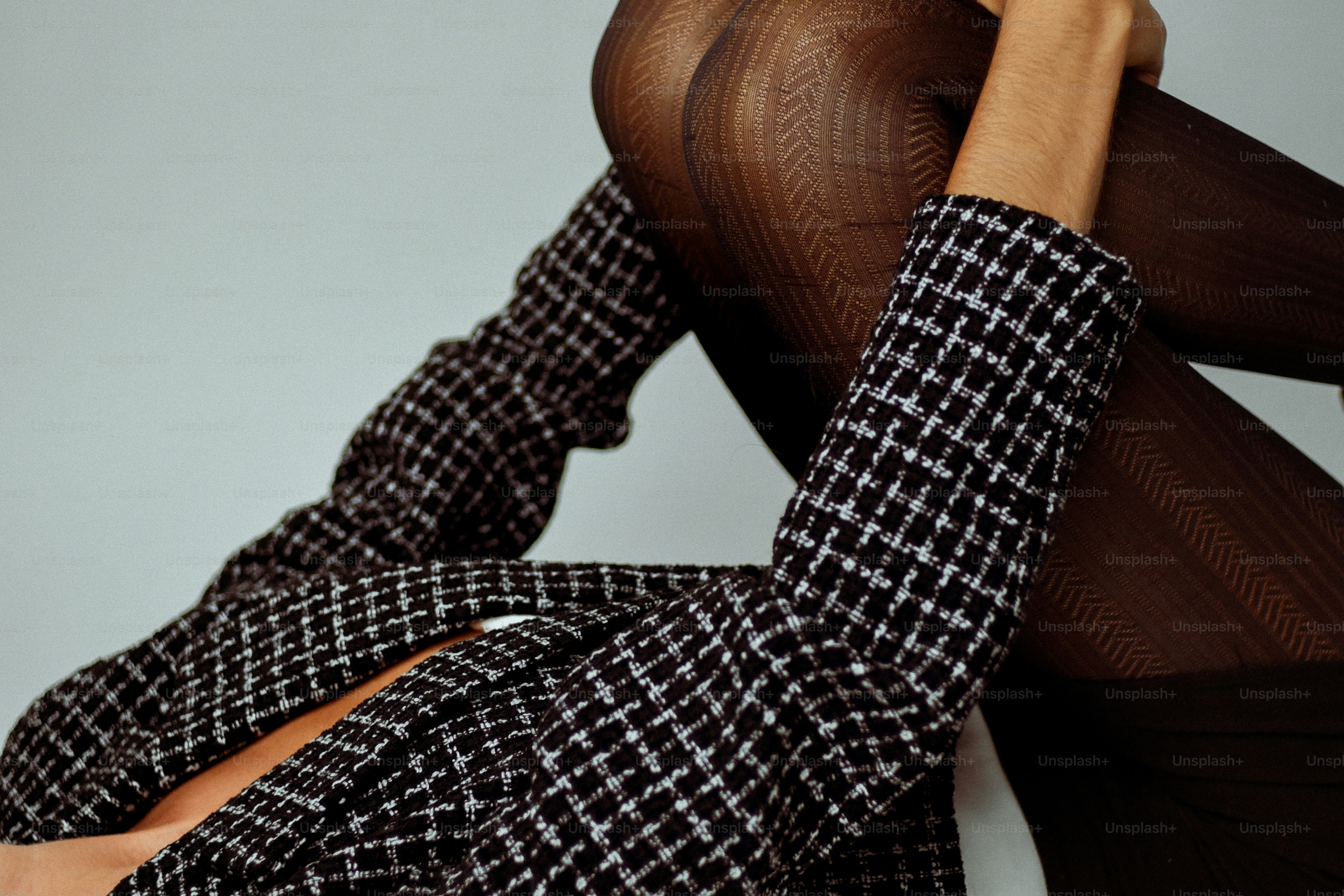 Woman in a patterned jacket and black tights