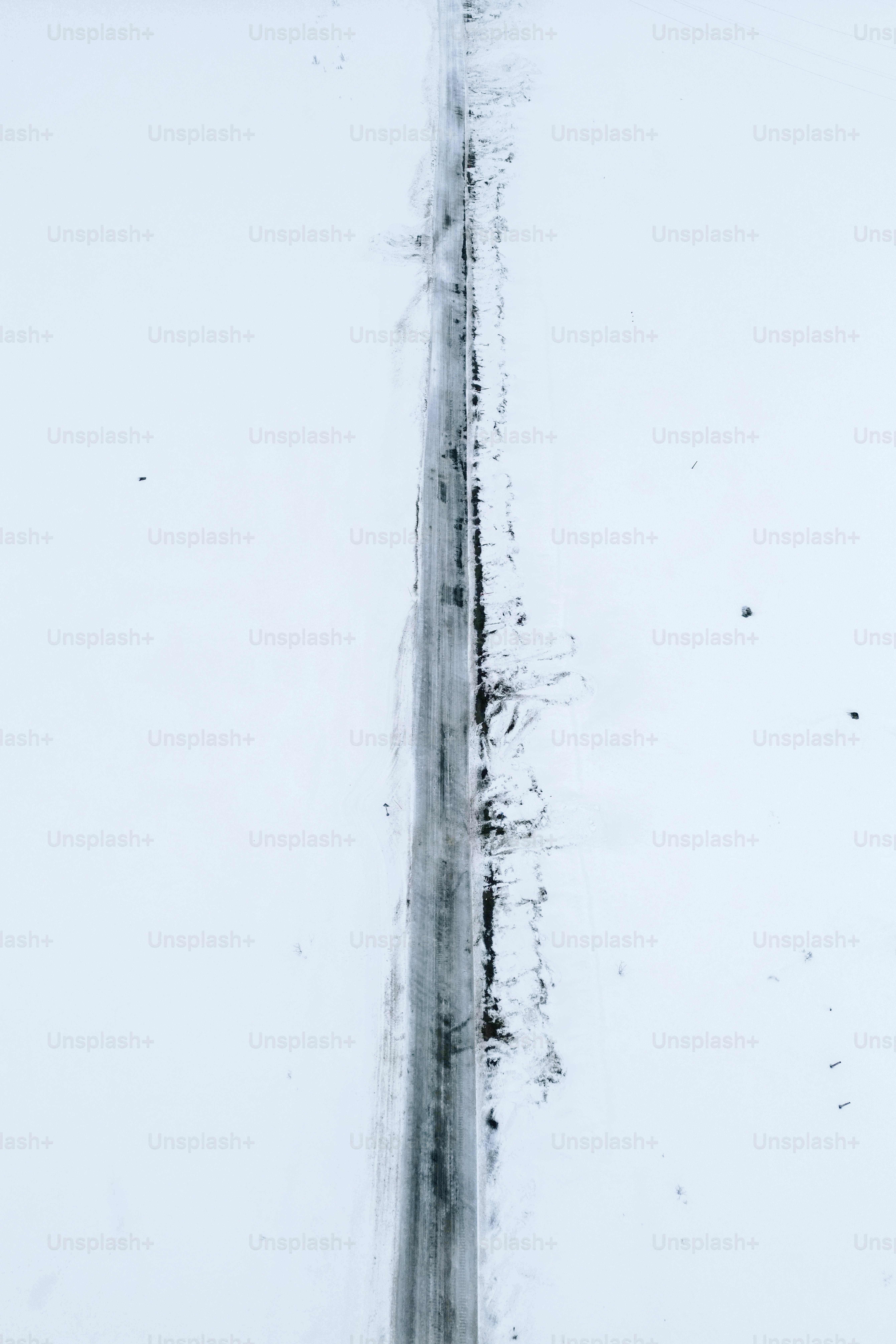 A straight road through a snowy landscape