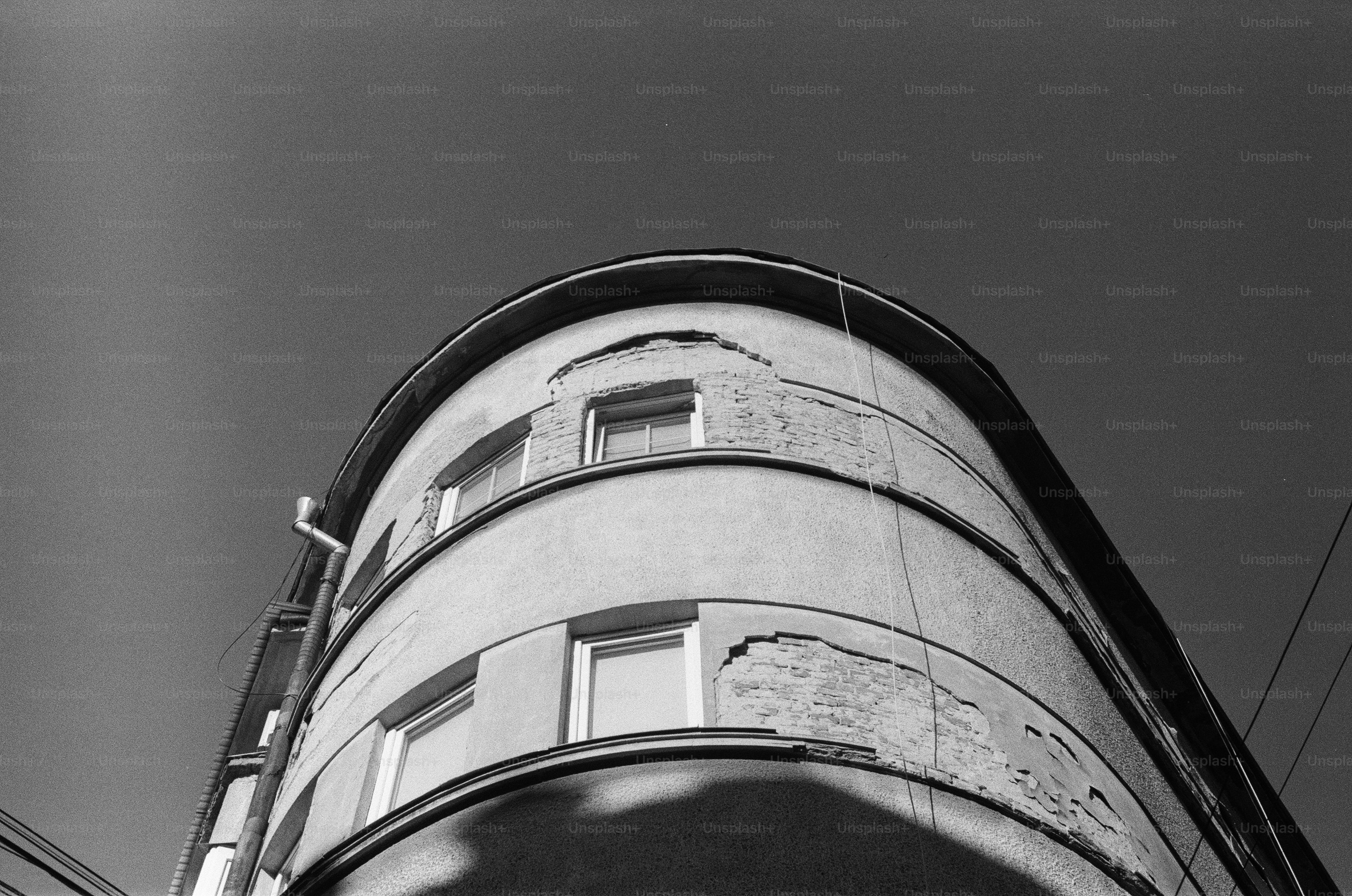 Curved building facade against a clear sky