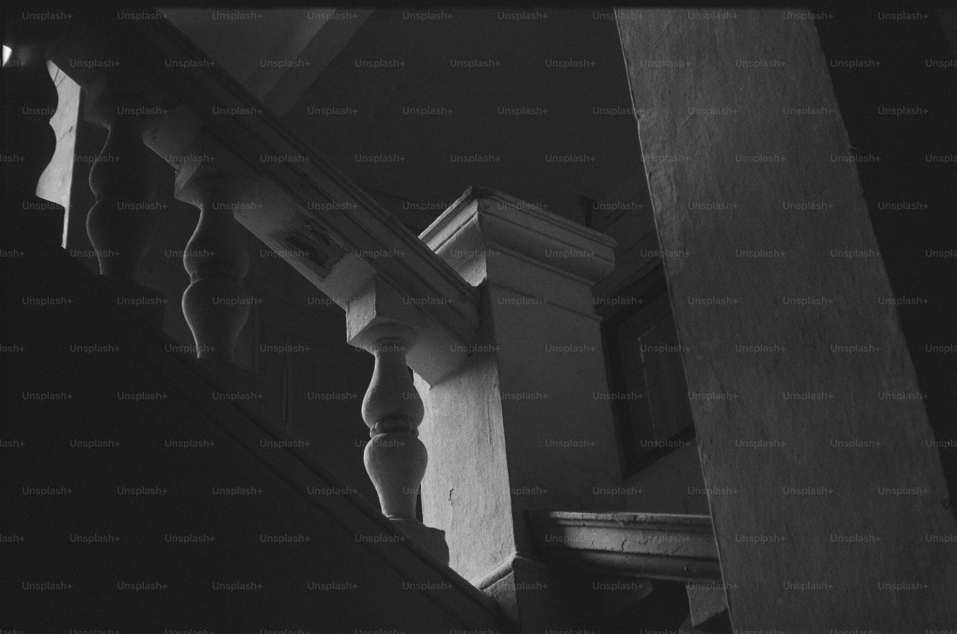 A dark, ornate staircase with a balustrade.