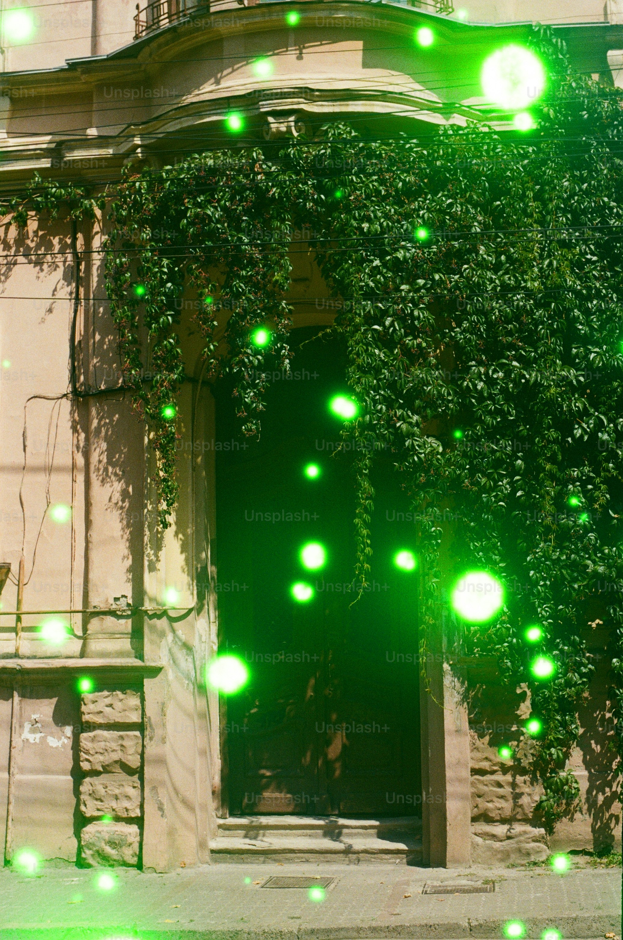 Green glowing orbs float around a building entrance.