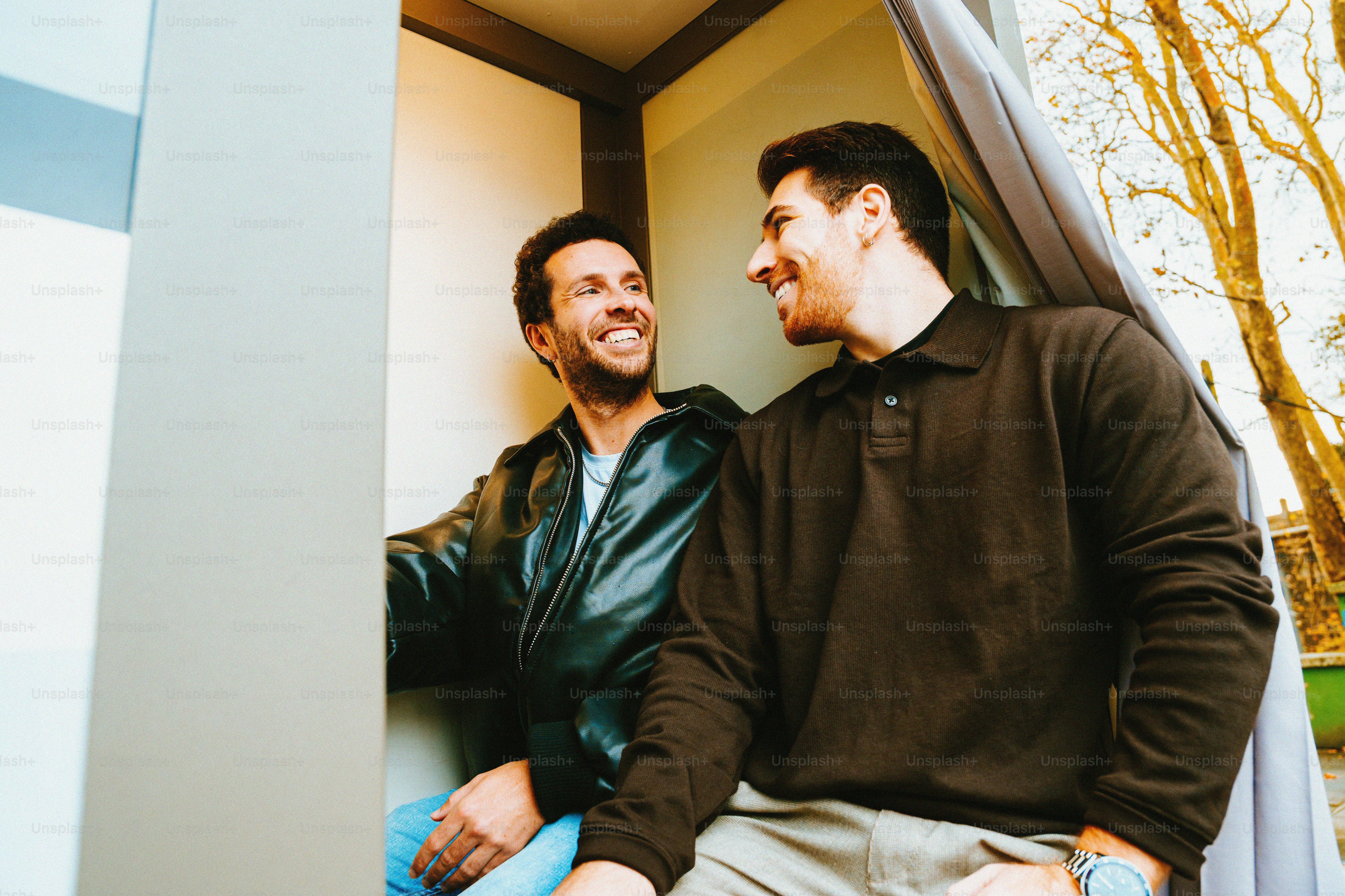 Two men smiling and looking at each other photo – Outdoor Image on Unsplash