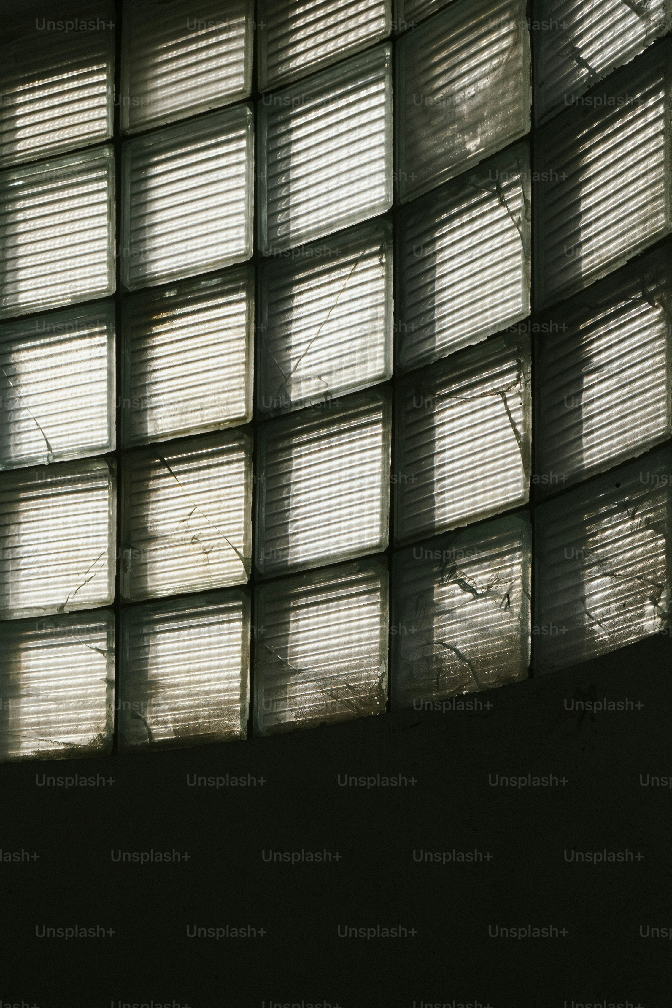 Curved glass block wall with sunlight filtering through