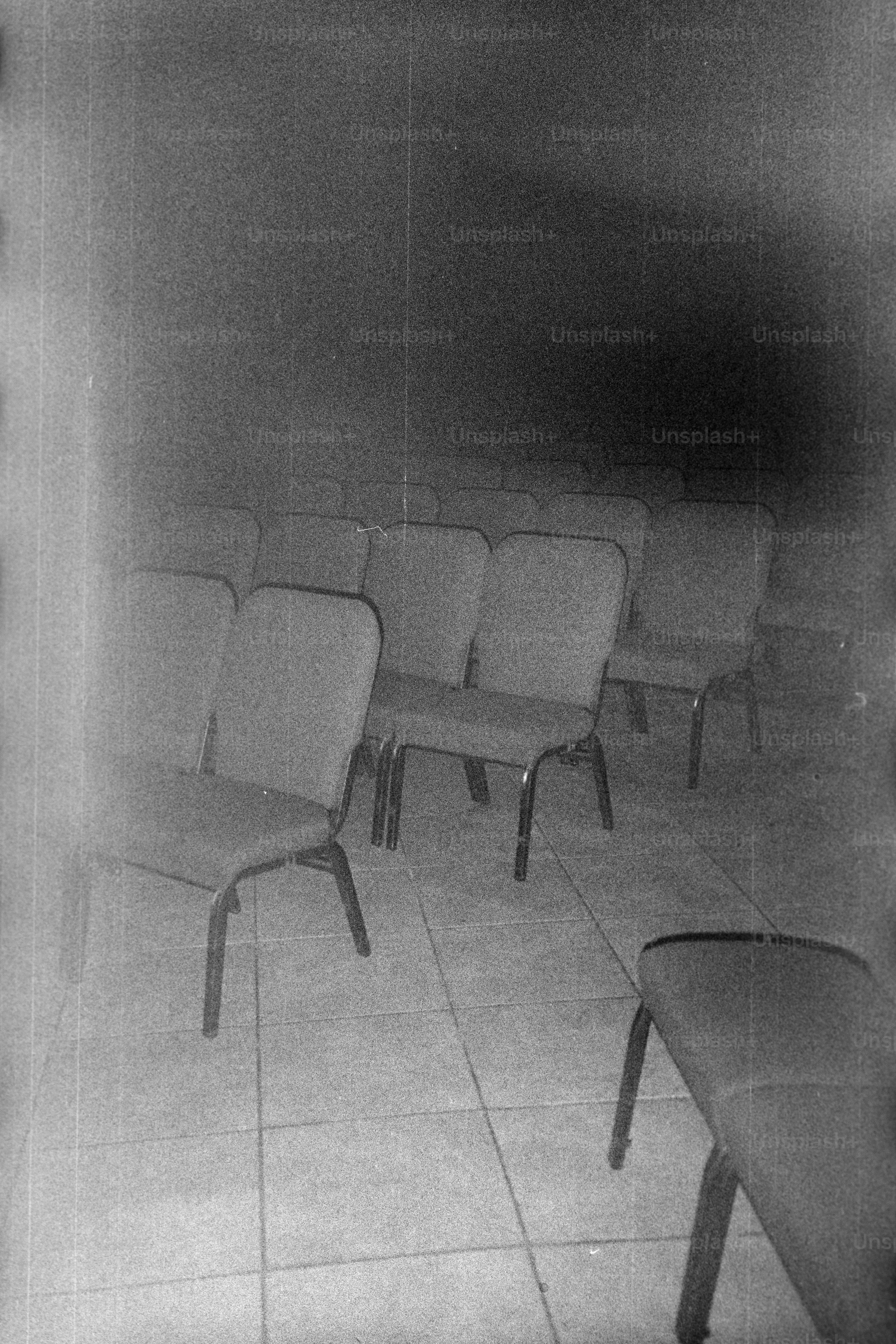Rows of empty chairs in a dimly lit room