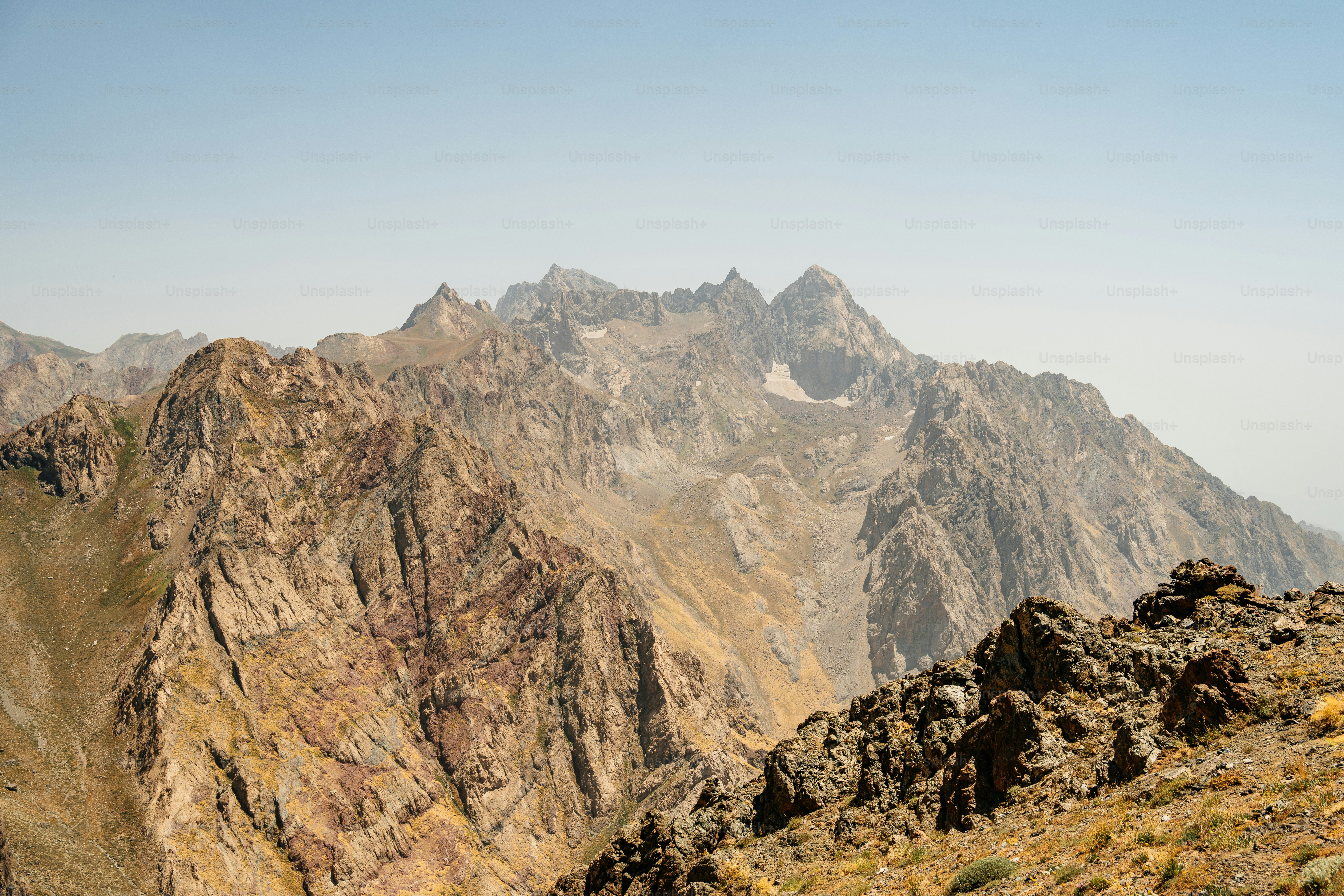 Rugged mountain range under a clear blue sky photo – Image on Unsplash