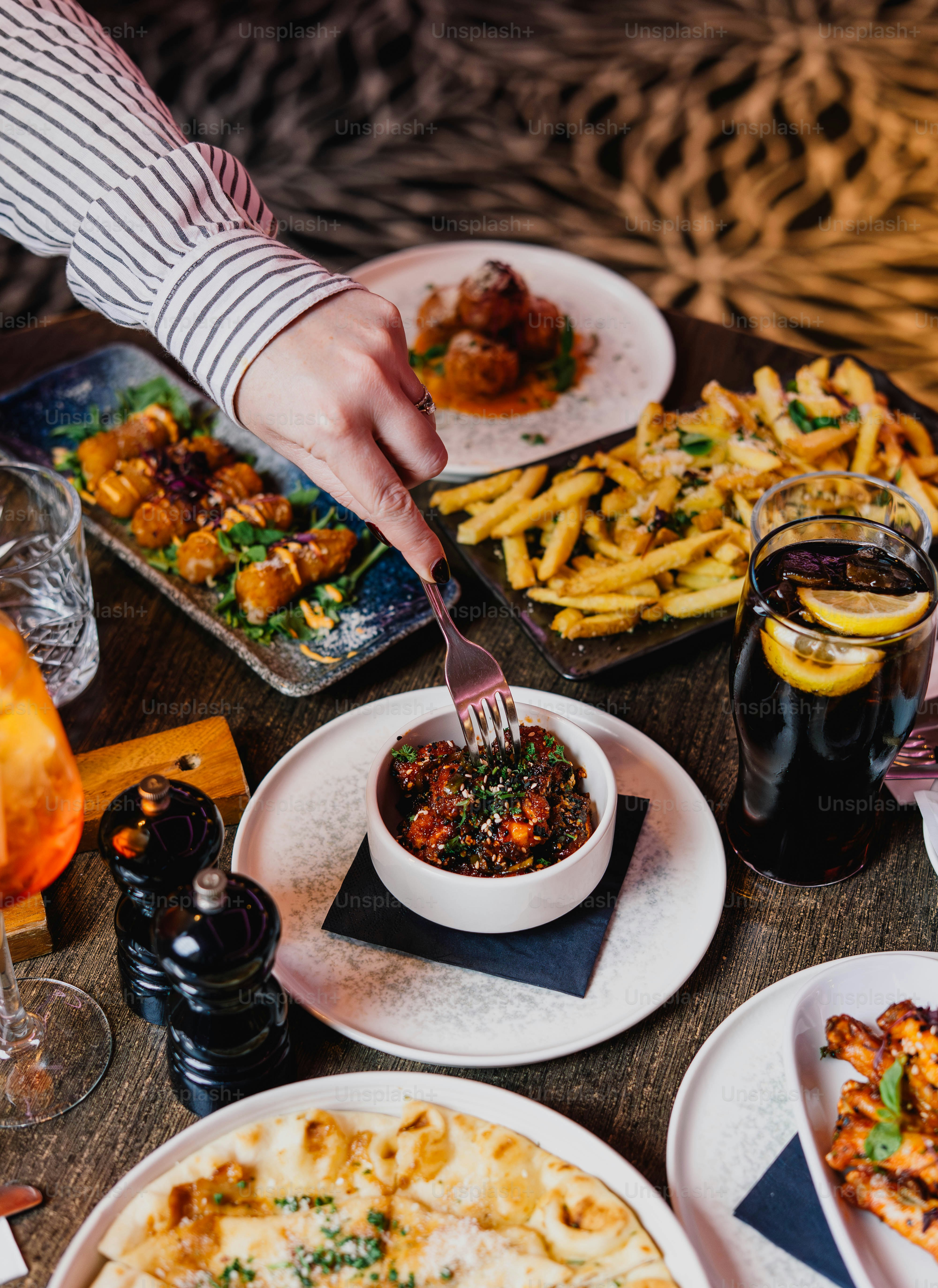 Person eating a small dish of food at a table
