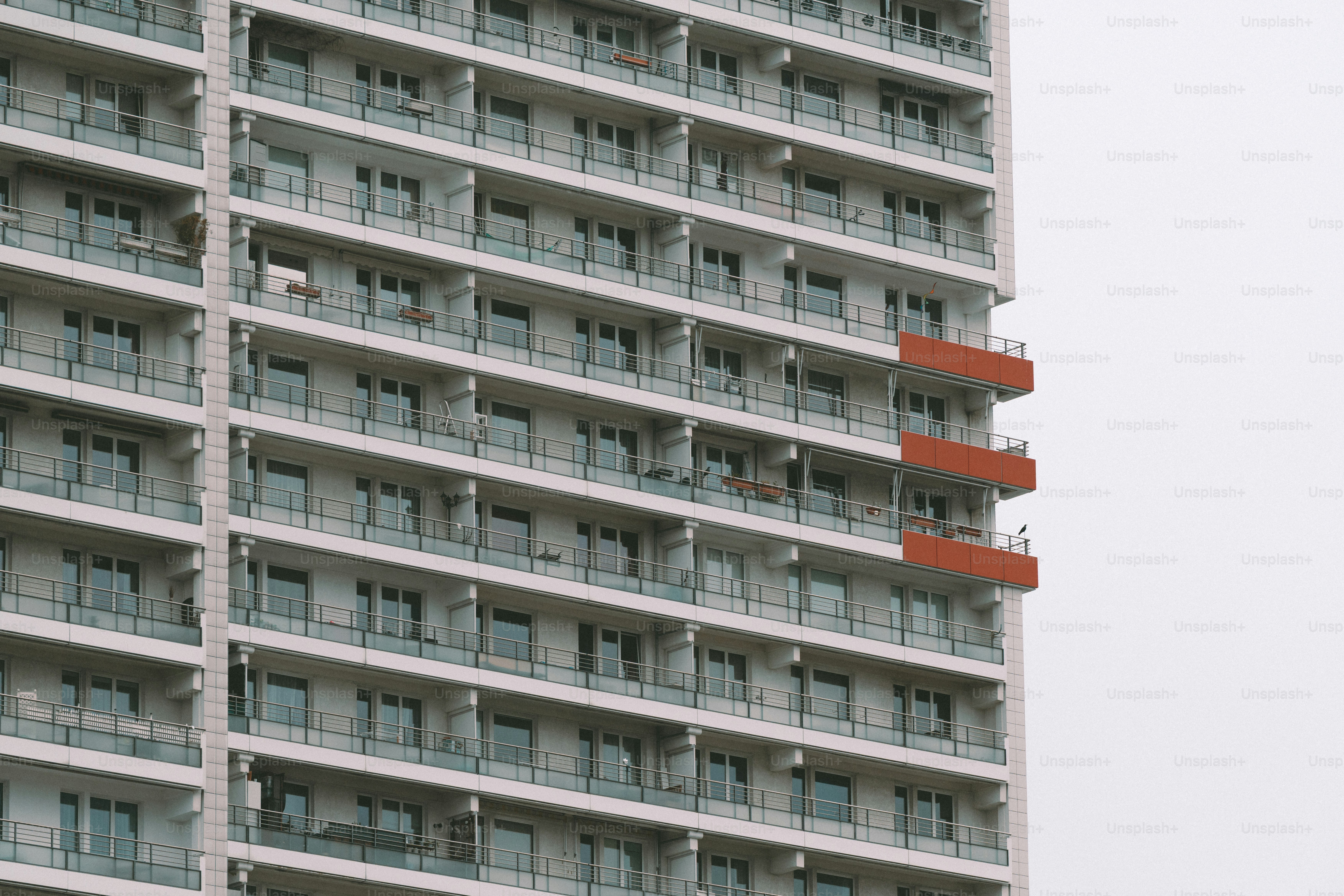 Modern apartment building with balconies against a cloudy sky