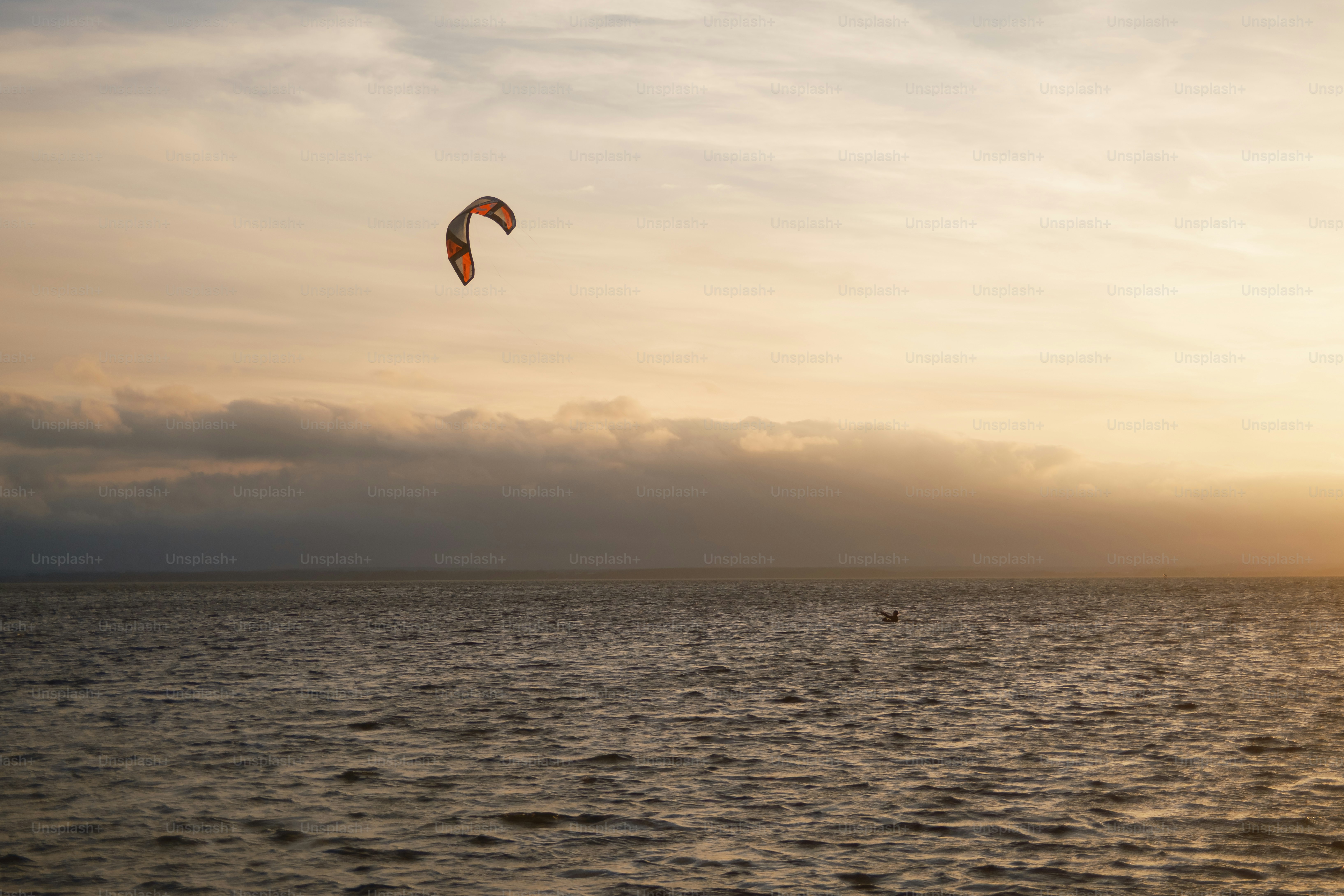 Kite surfer on the ocean at sunset
