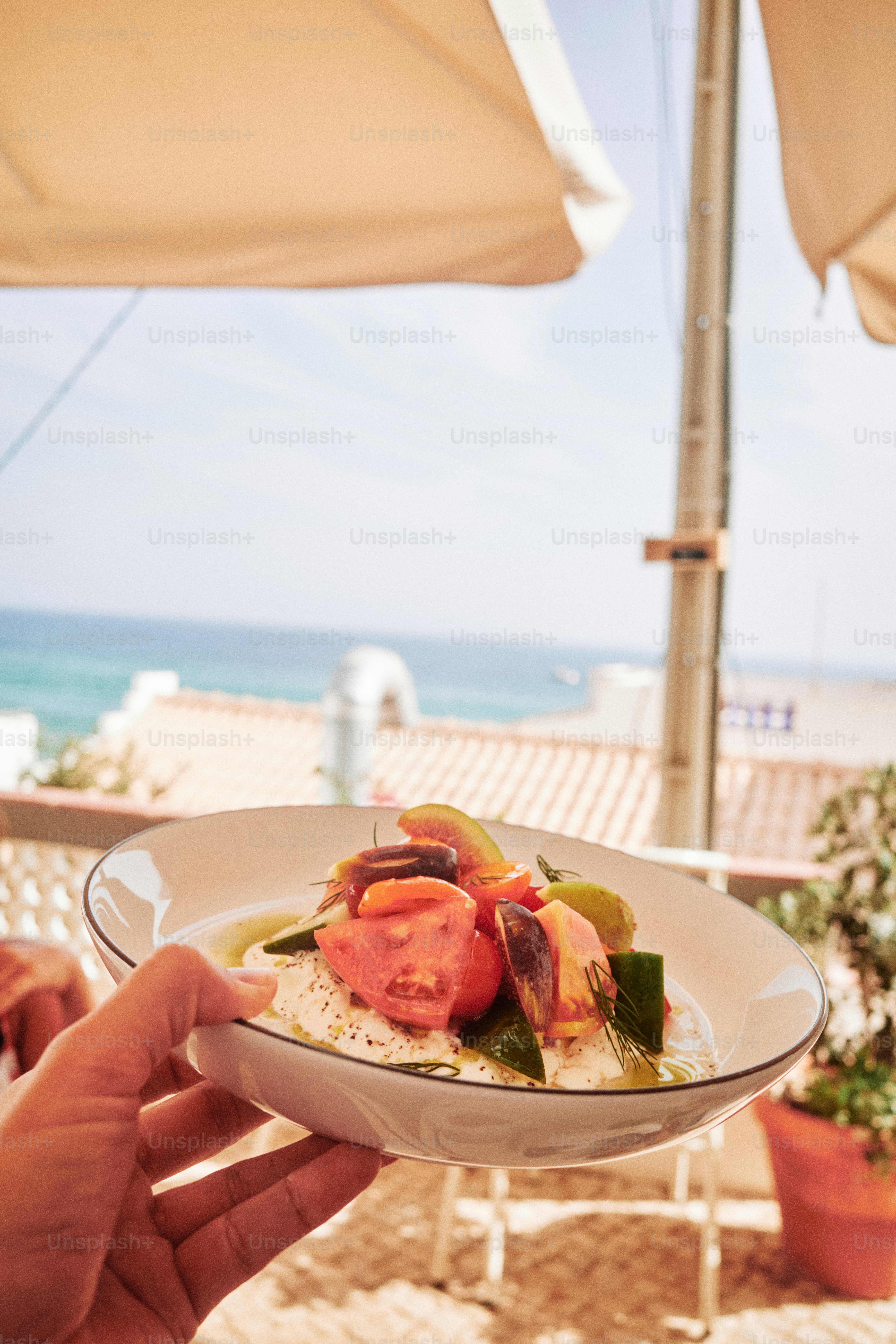Fresh salad with tomatoes and seafood by the sea.